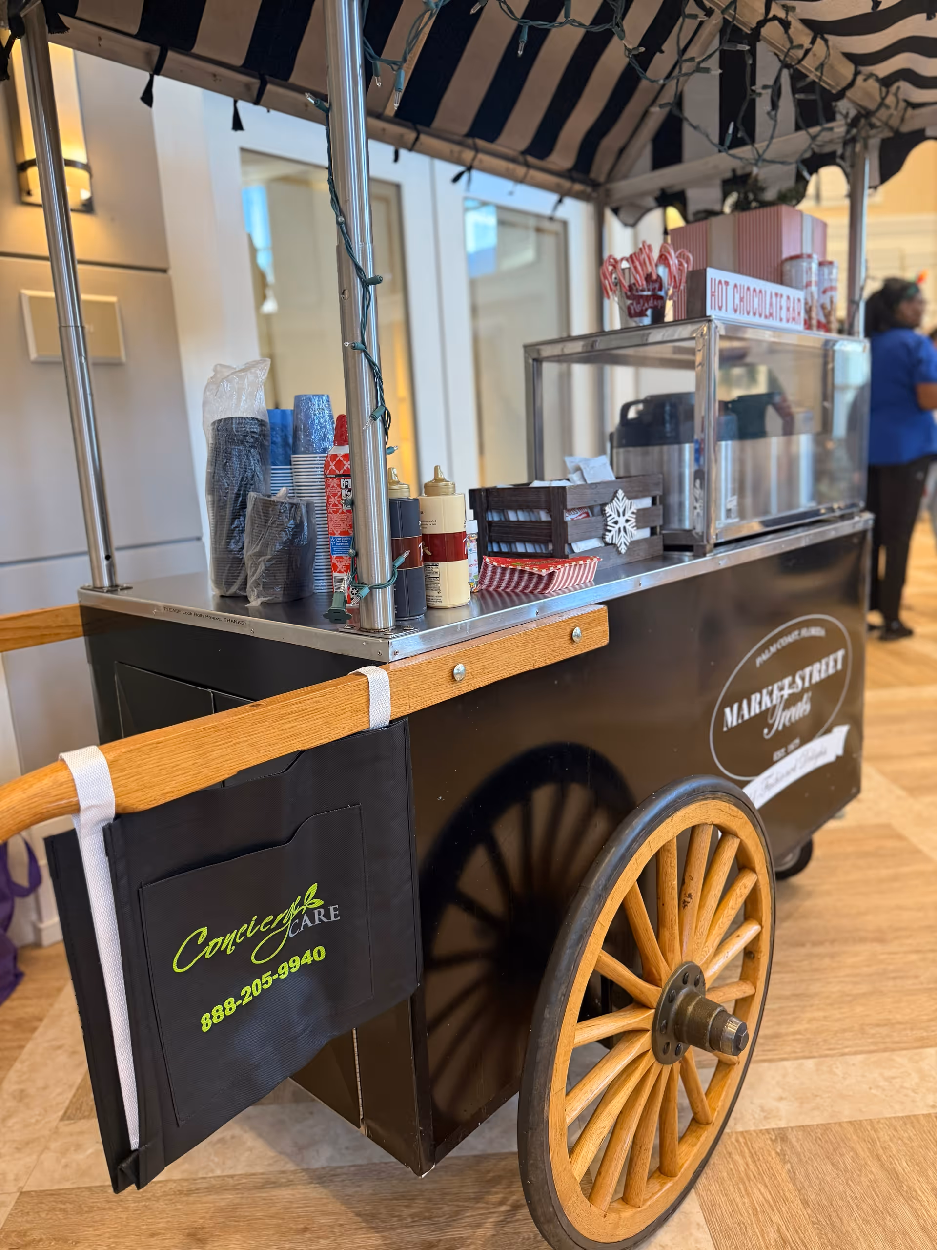 Interior beverage cart labeled Concierge Care with a hot chocolate bar in lobby.
