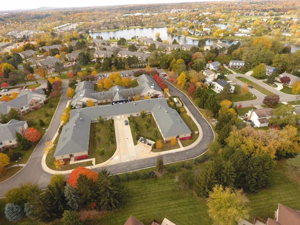 Aerial view of Addington Place of Northville campus with interconnected buildings and autumn trees.