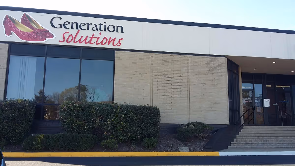 Exterior view of a building with a Generation Solutions sign and entrance stairs.