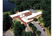 Aerial view of Glenwood Park senior living facility with trees and parking.