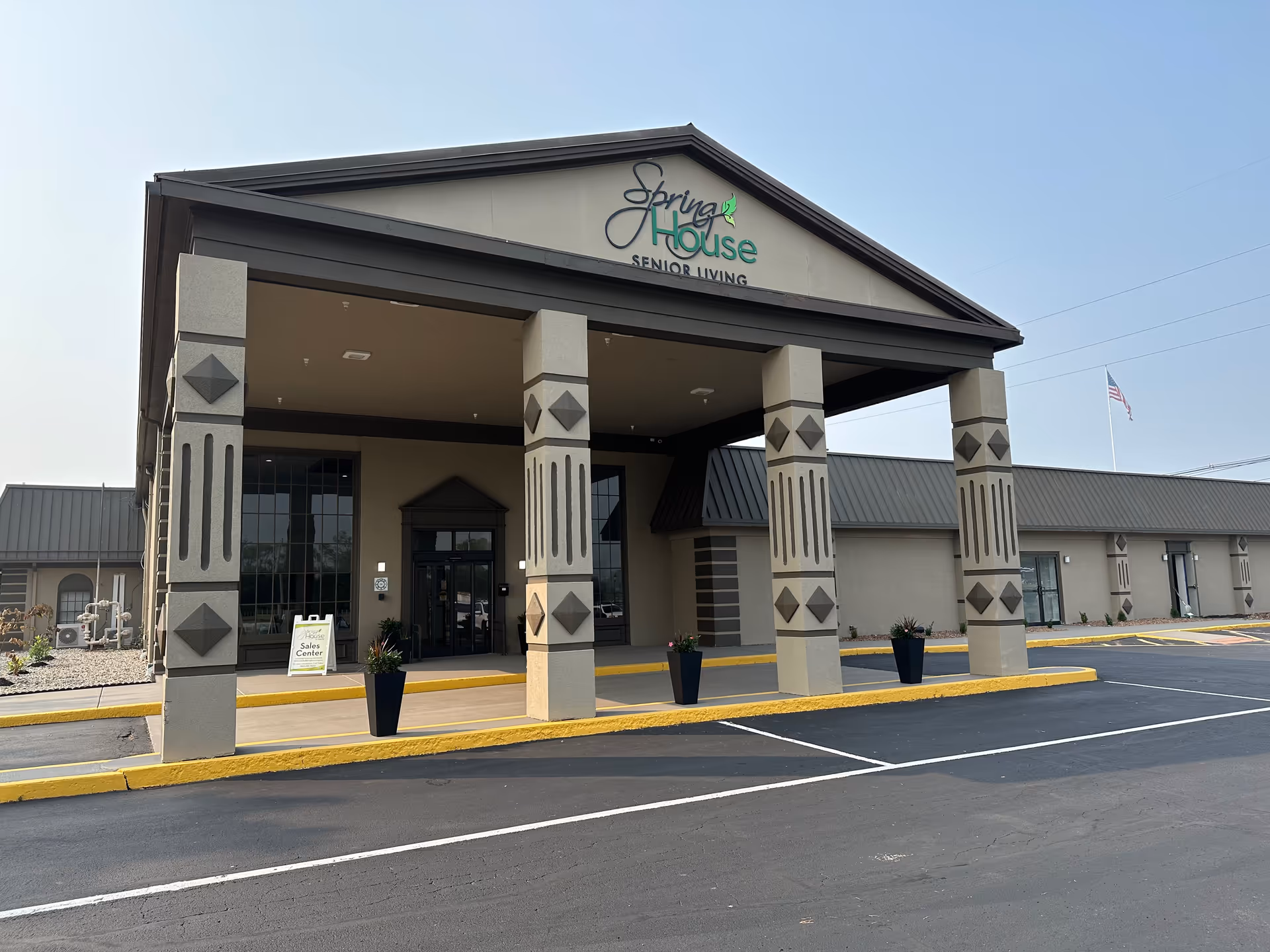 Front view of Spring House Senior Living building with pillars and covered entrance.