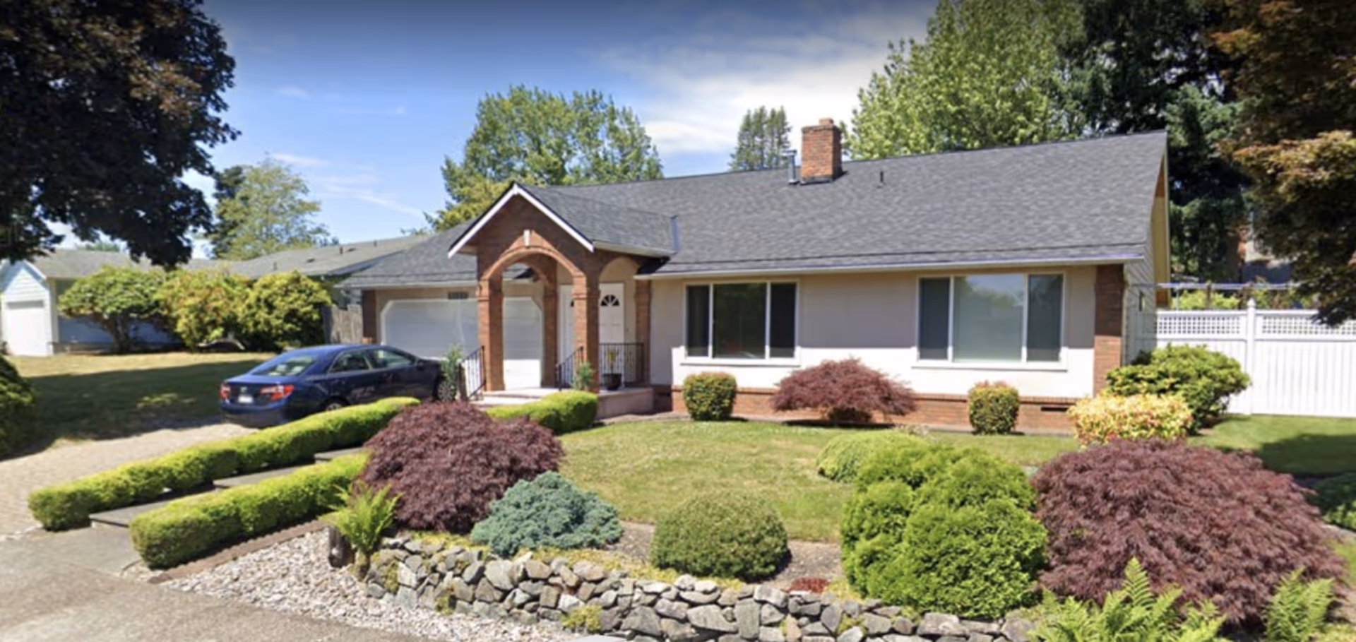 Front view of a single-story home with a well-kept yard and driveway.