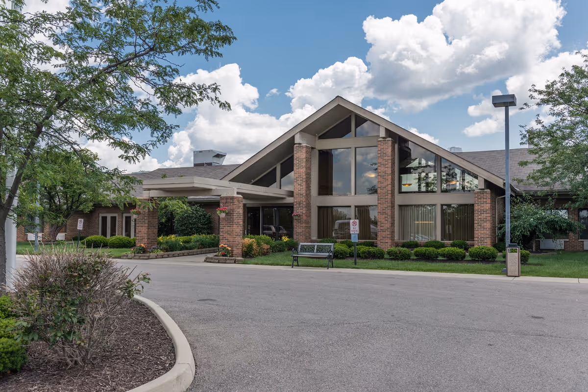 Front exterior view of Legacy Miamisburg facility with brick entrance and landscaped surroundings.
