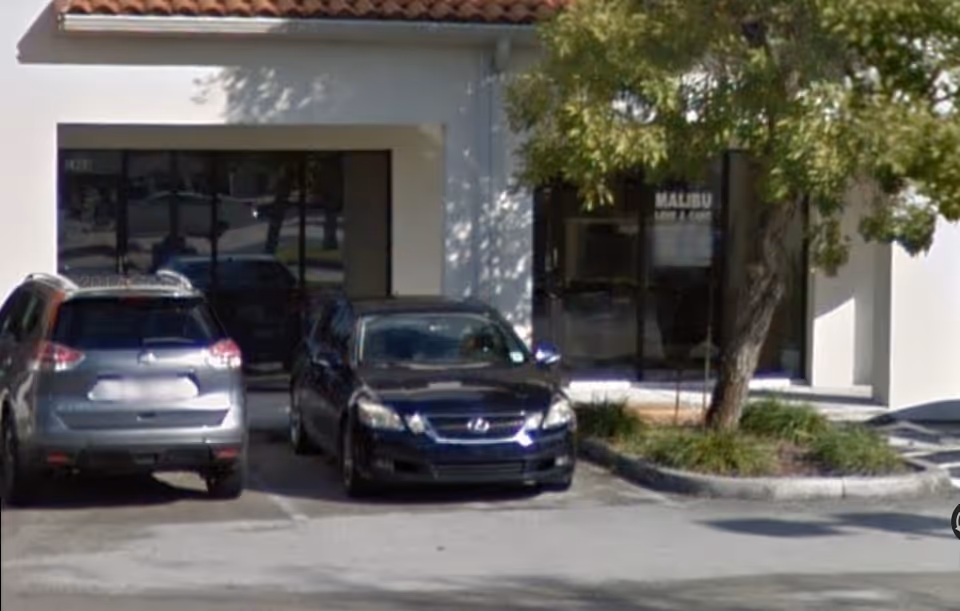 Exterior view of Malibu Love & Care Healthcare Agency storefront with parked cars.