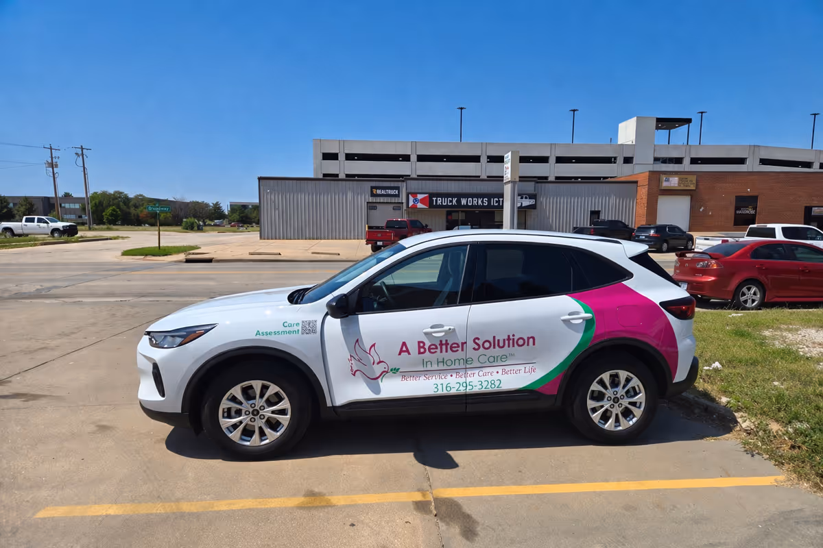 Branded A Better Solution In Home Care Tulsa vehicle parked outside a commercial building.