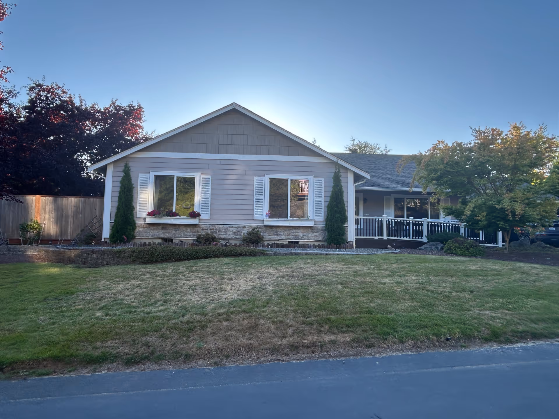 Single-story residential care home with manicured lawn and a covered front porch.