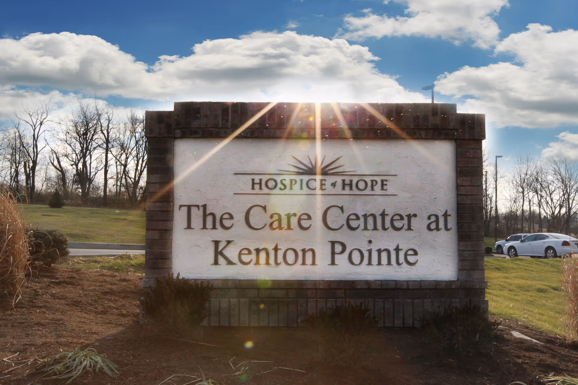 Exterior sign for Hospice of Hope The Care Center at Kenton Pointe beside a parking lot