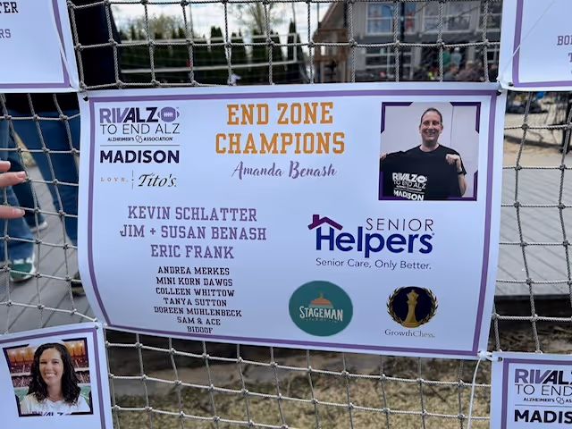 Outdoor fence banner displaying Senior Helpers Madison and End Zone Champions with sponsor logos.