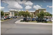 Exterior view of Gino J Merli Veterans Center with parking lots and trees.
