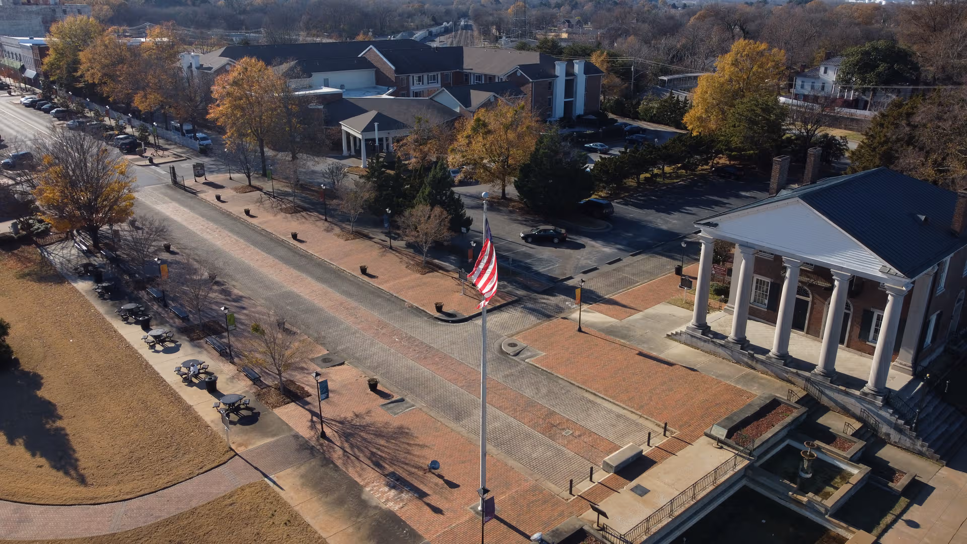 Aerial view of City Center Village Senior Community exterior with brick plaza and flagpole.