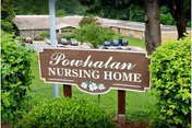 Powhatan Nursing Home sign in front of greenery with building in background