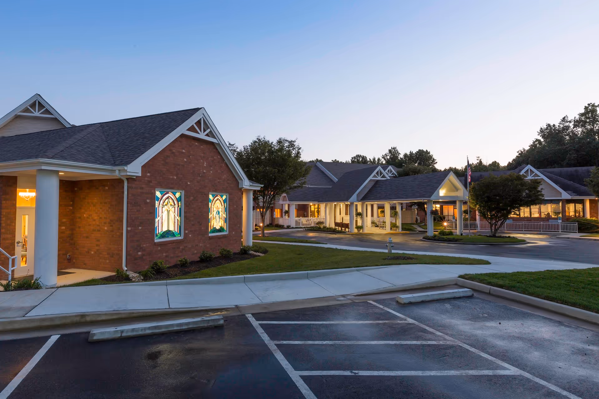 Exterior view of a senior living campus with brick buildings and a parking lot