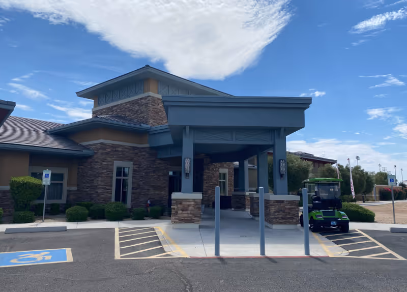 Front entrance of Mosaic Gardens Memory Care at Surprise with a covered entryway.