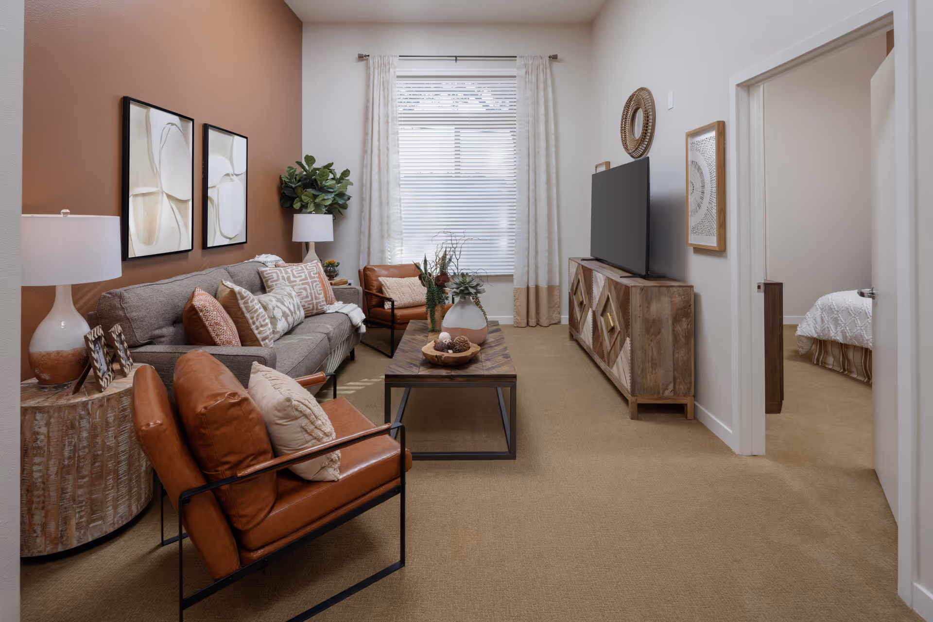 Cozy Clearwater at Glendora living room with sofa, chairs, coffee table, and TV.