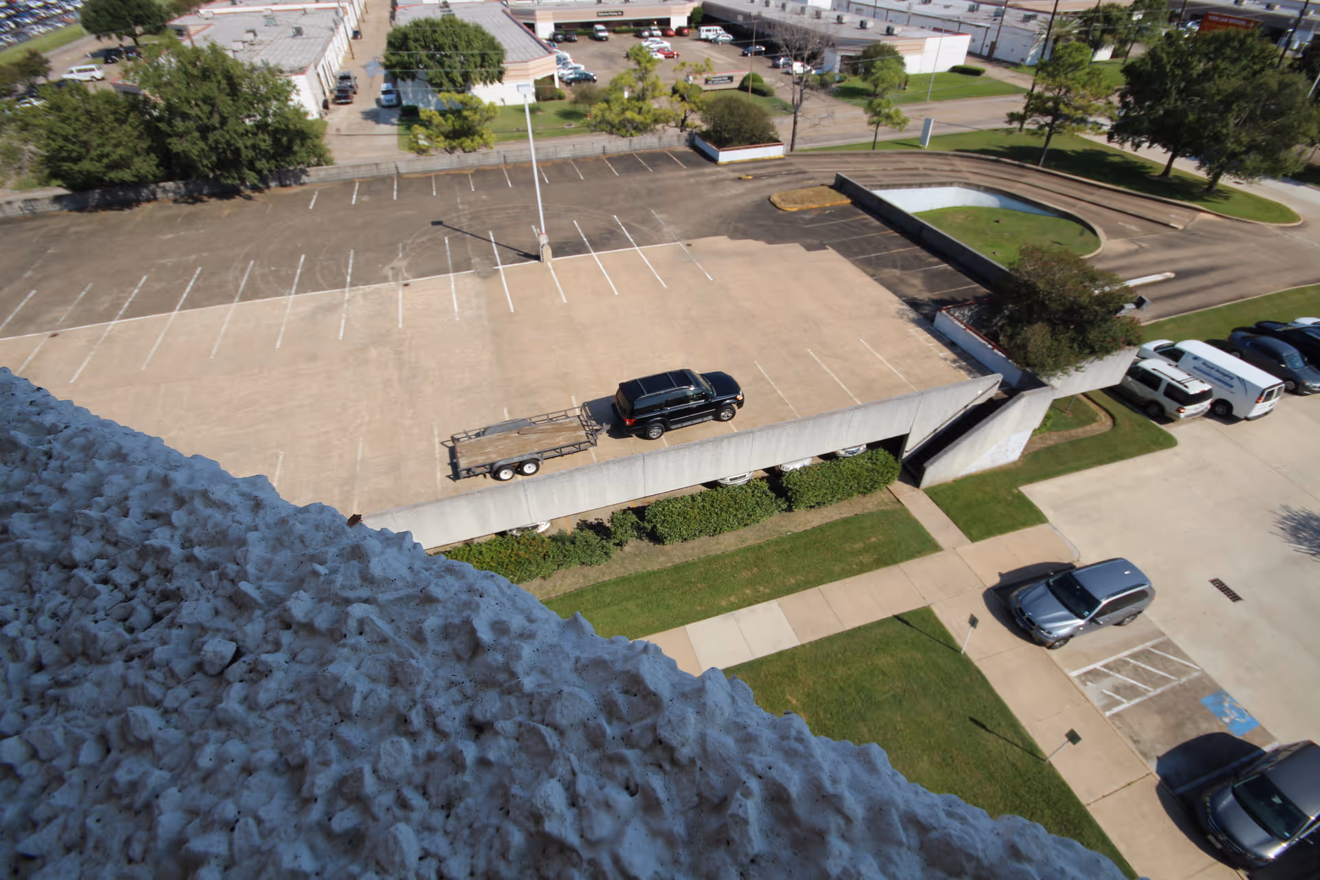 Aerial view of a senior living facility's parking lot and surrounding grounds.