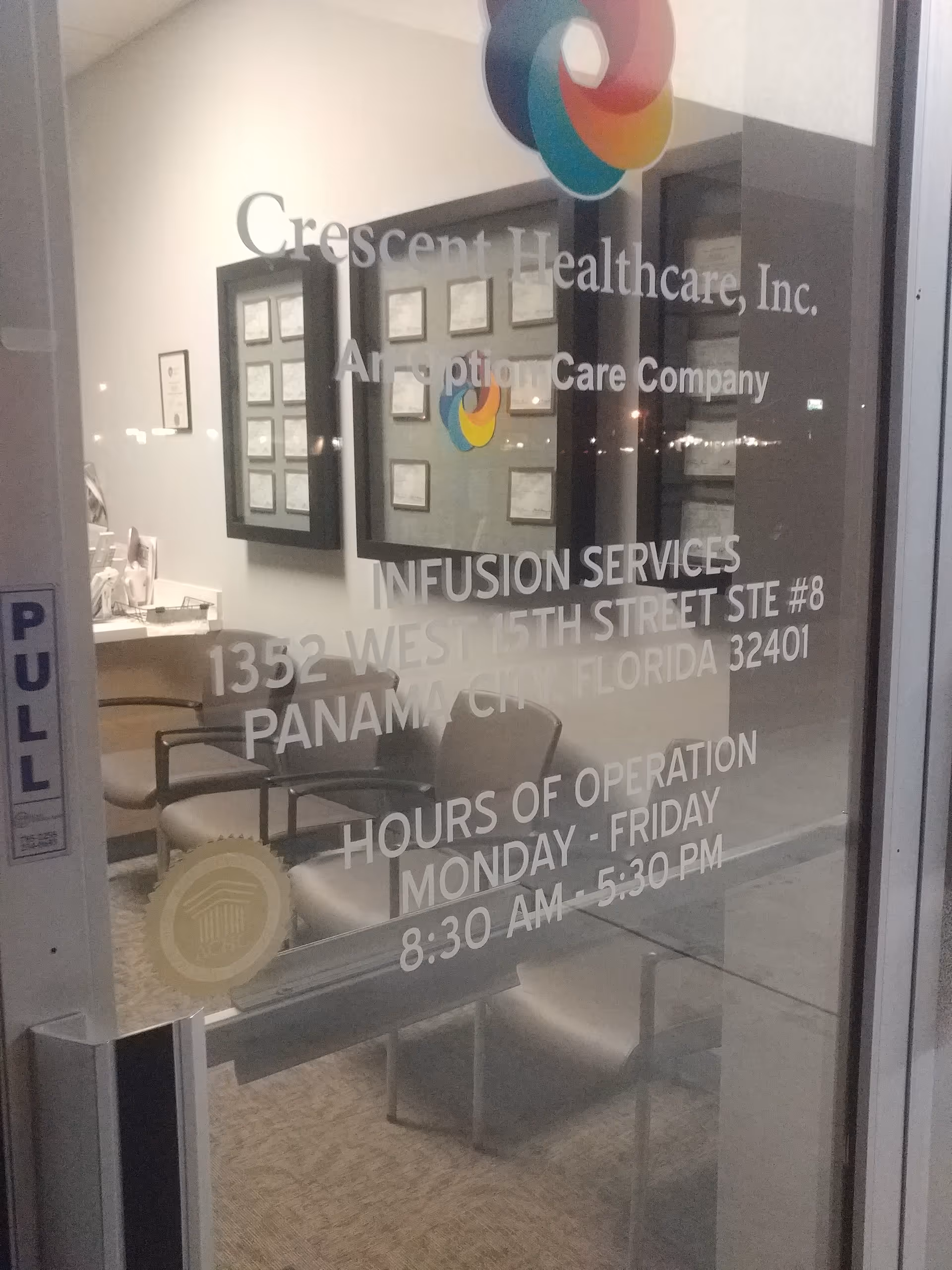 Glass door displays Crescent Healthcare signage, revealing an interior reception lobby and framed certificates.