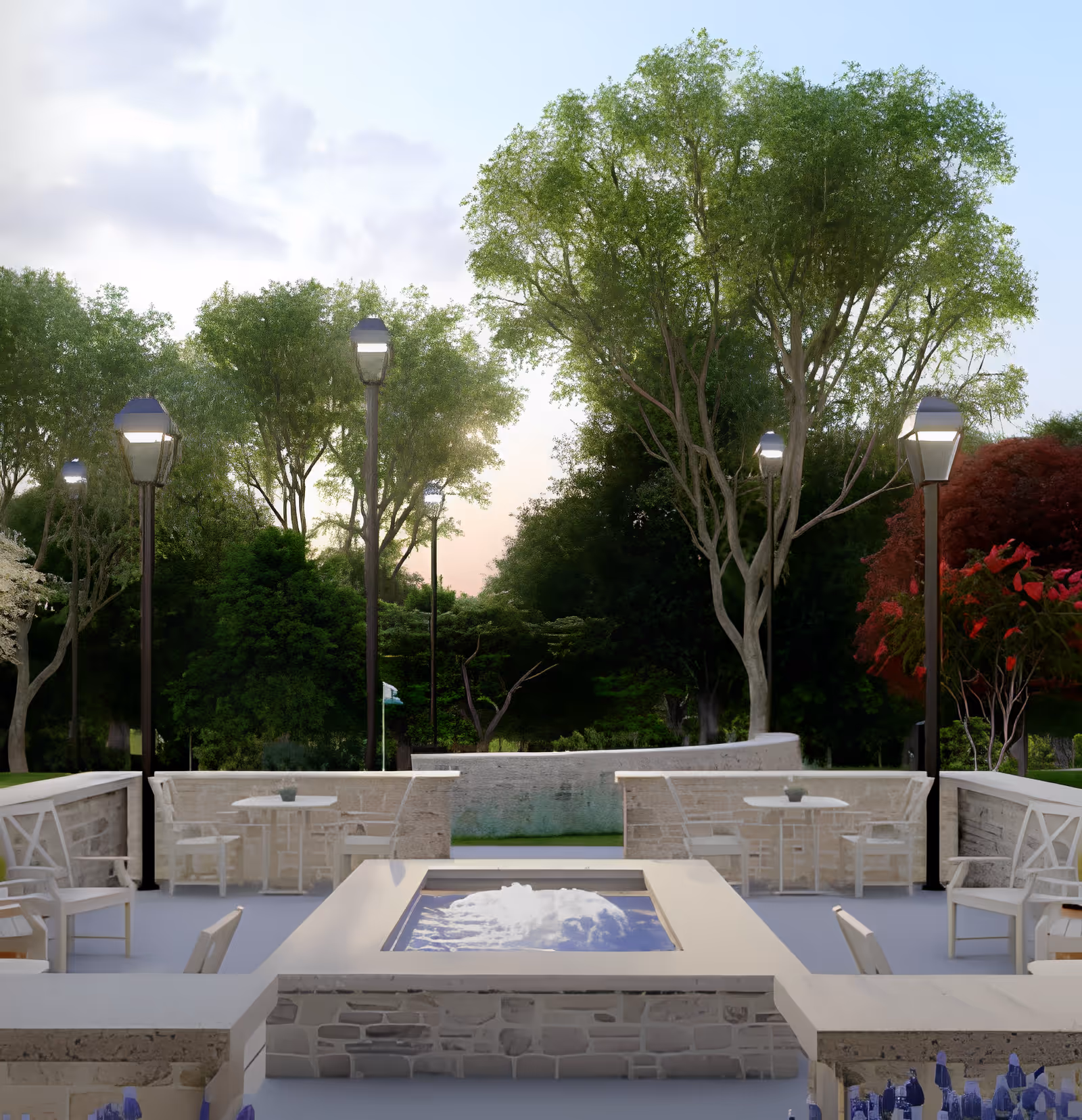 Outdoor patio courtyard with a central rectangular water feature surrounded by seating, lamp posts, and trees.