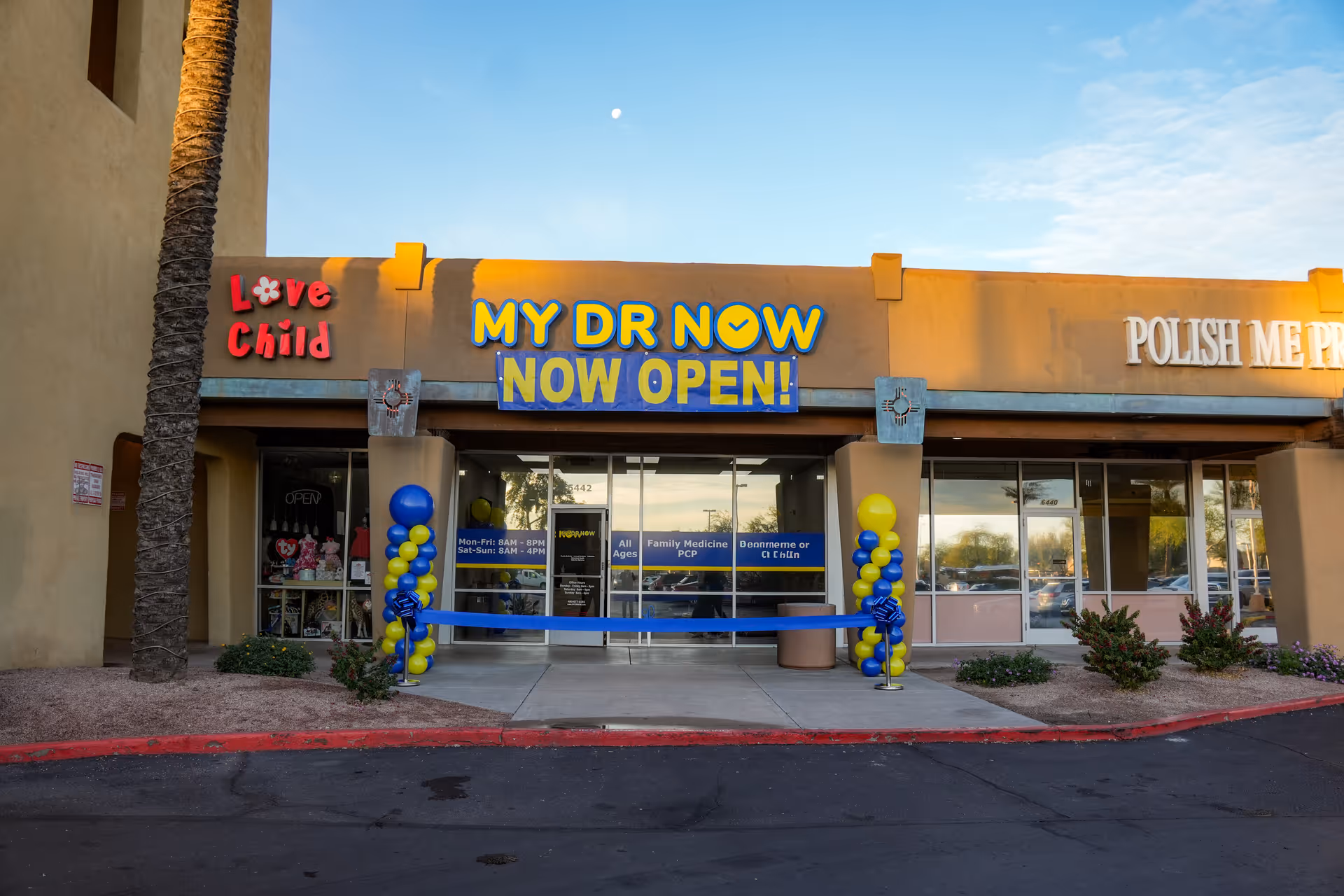 Front entrance of a clinic with MY DR NOW NOW OPEN signage and balloon decorations.