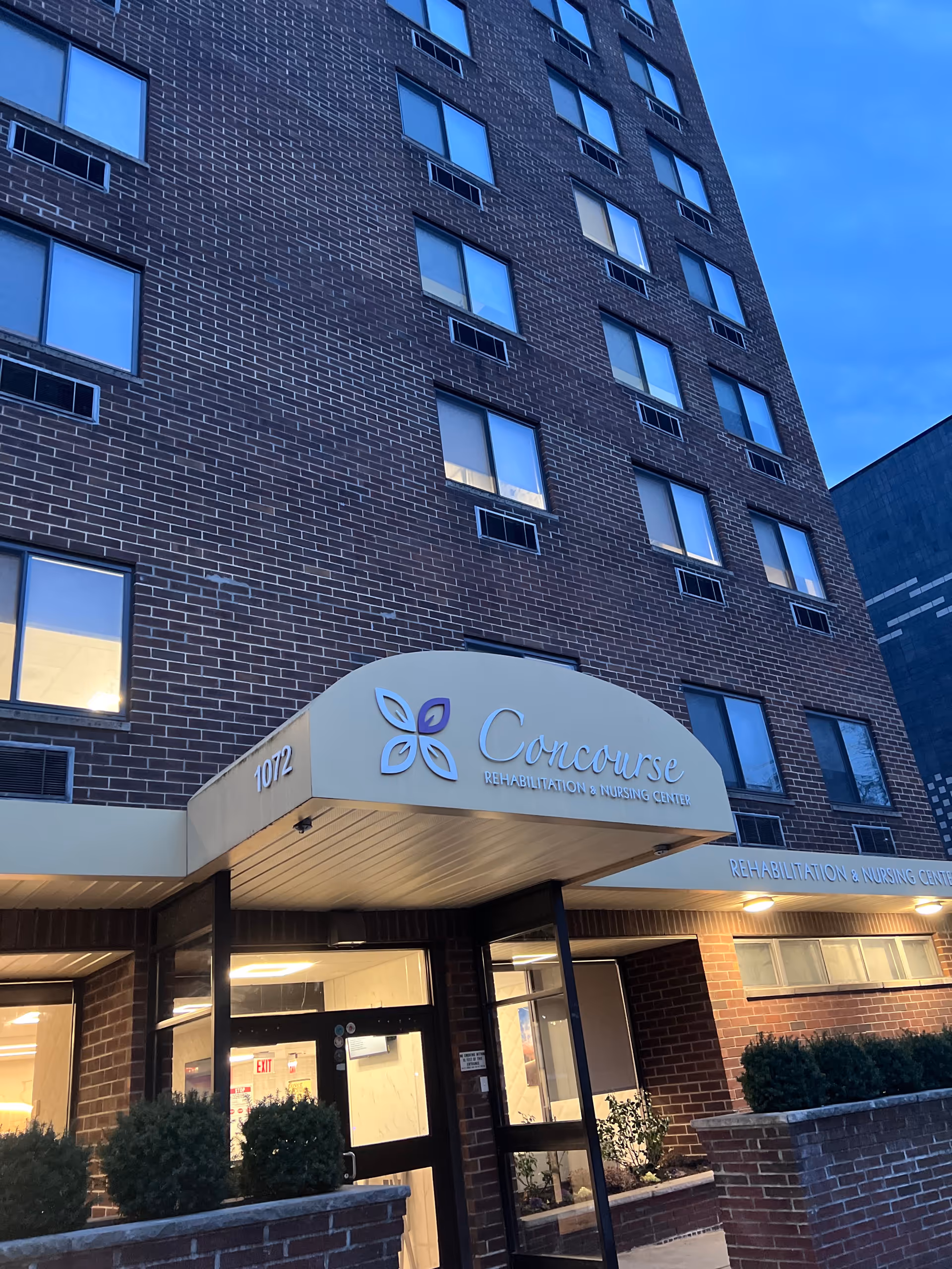 Tall brick building with a curved entrance sign reading Concourse Rehabilitation and Nursing Center.
