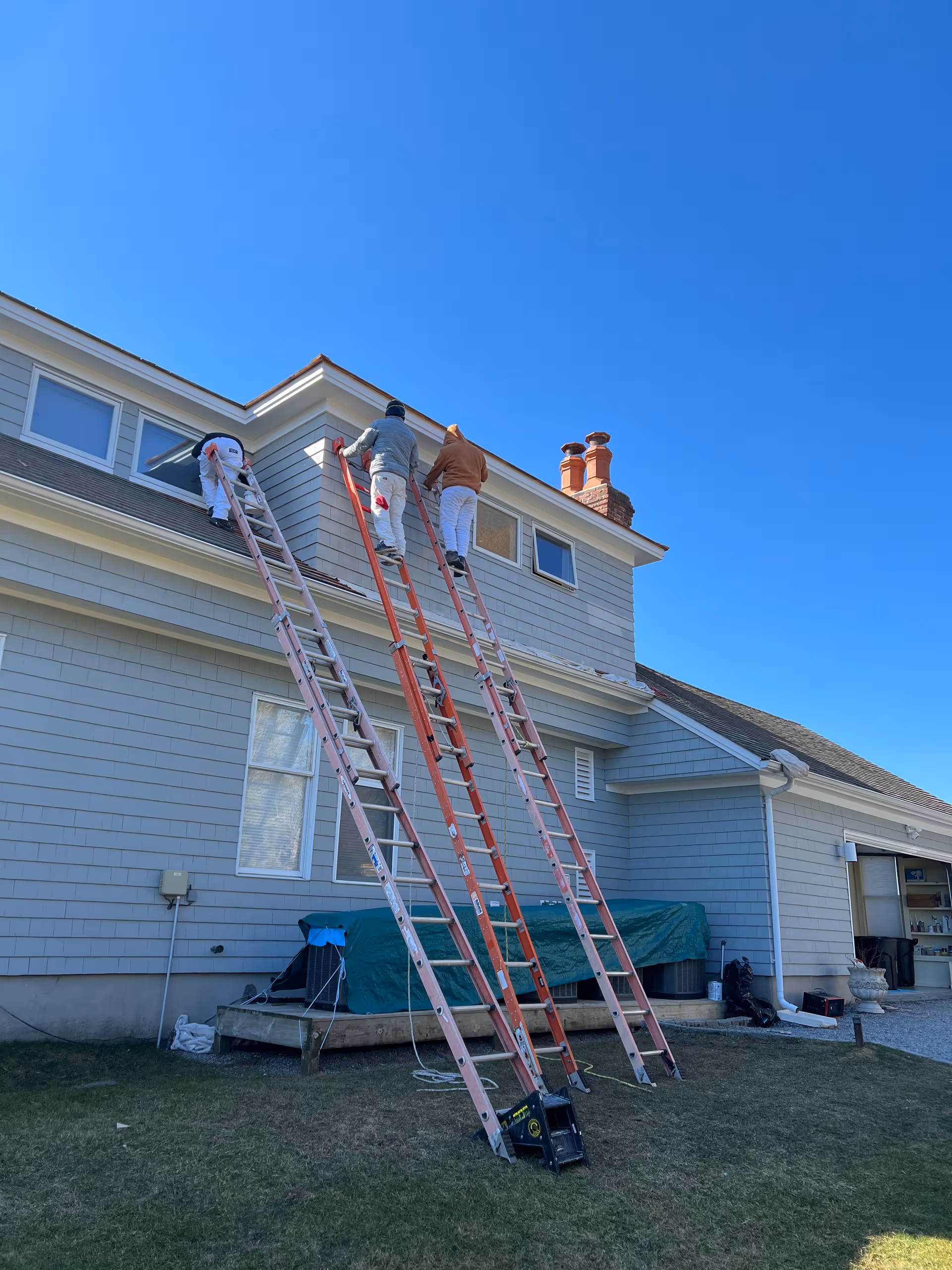 Westhampton Care Center exterior showing three workers on ladders painting the upper facade.