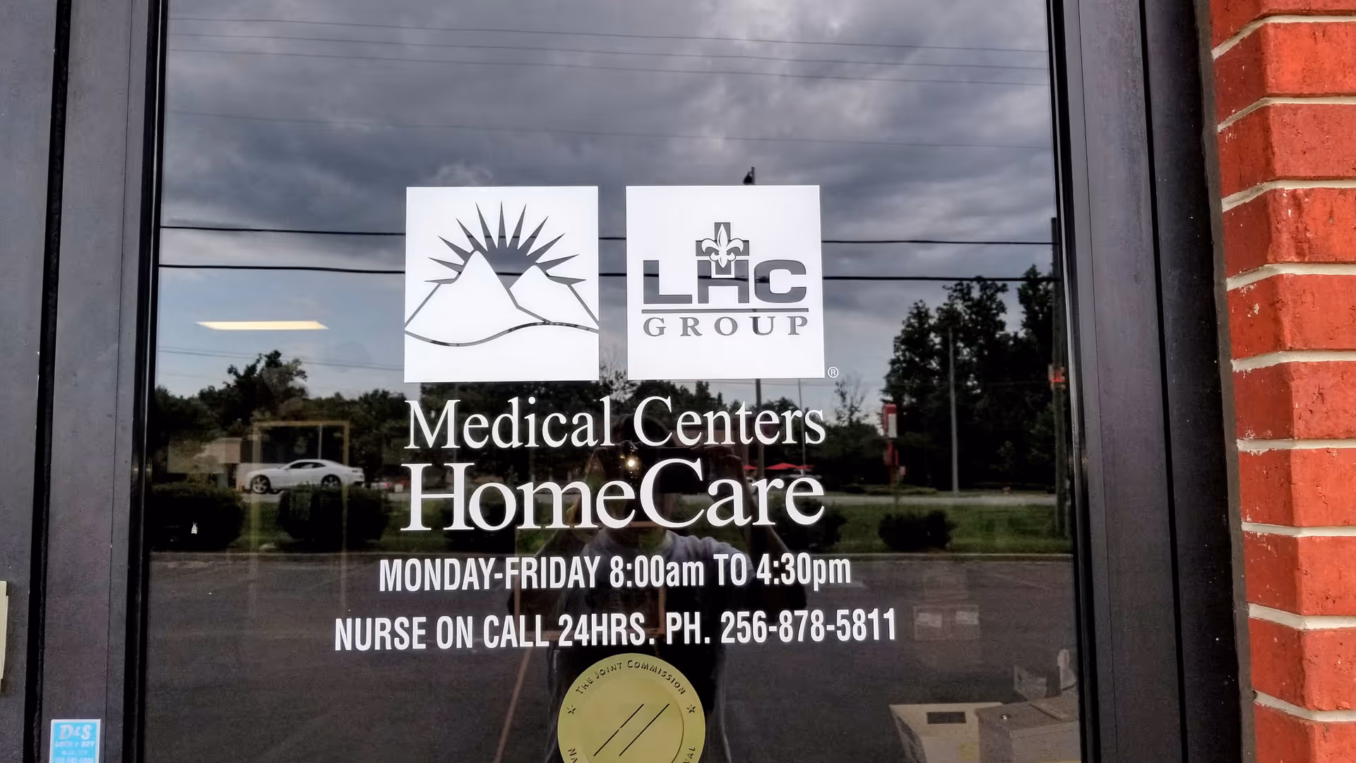 Exterior storefront door displays Medical Centers HomeCare signage and logos on glass.