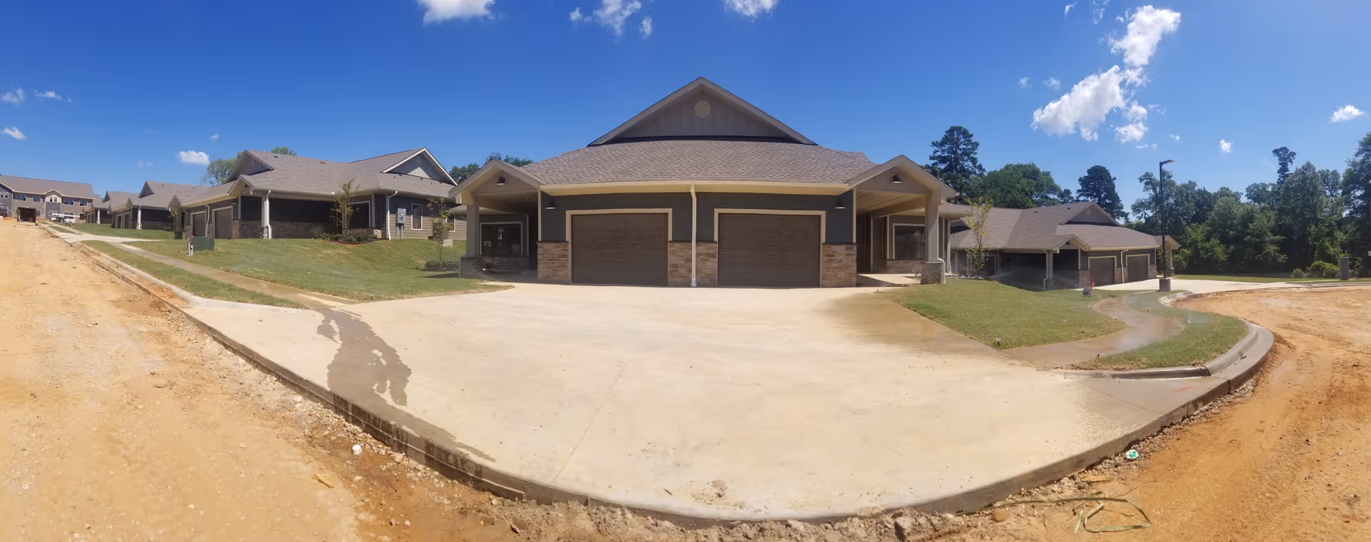 Exterior view of Primrose Retirement Community of Tyler buildings with garages and driveways.