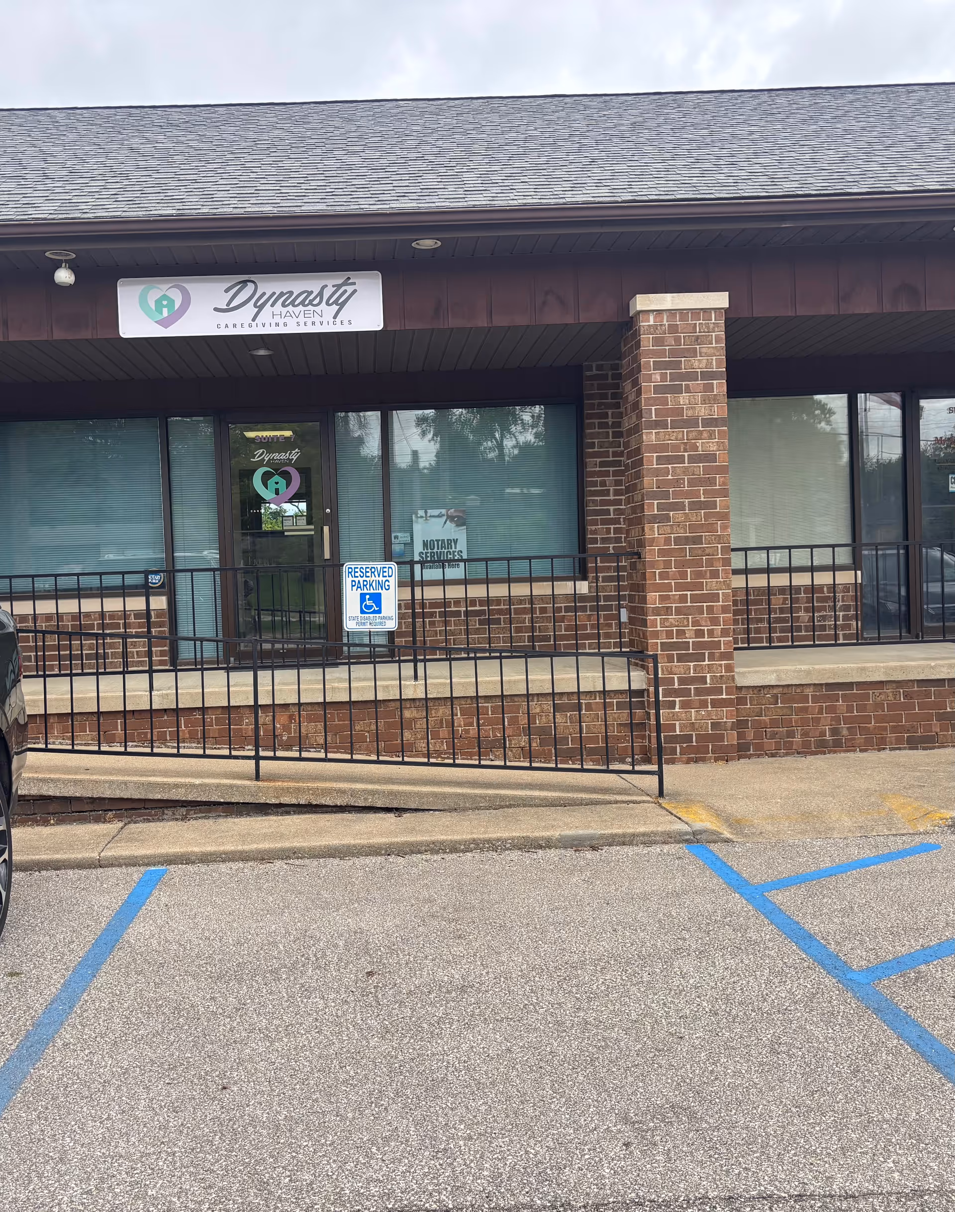 Front exterior of Dynasty Haven, LLC facility with brick facade and glass entrance.
