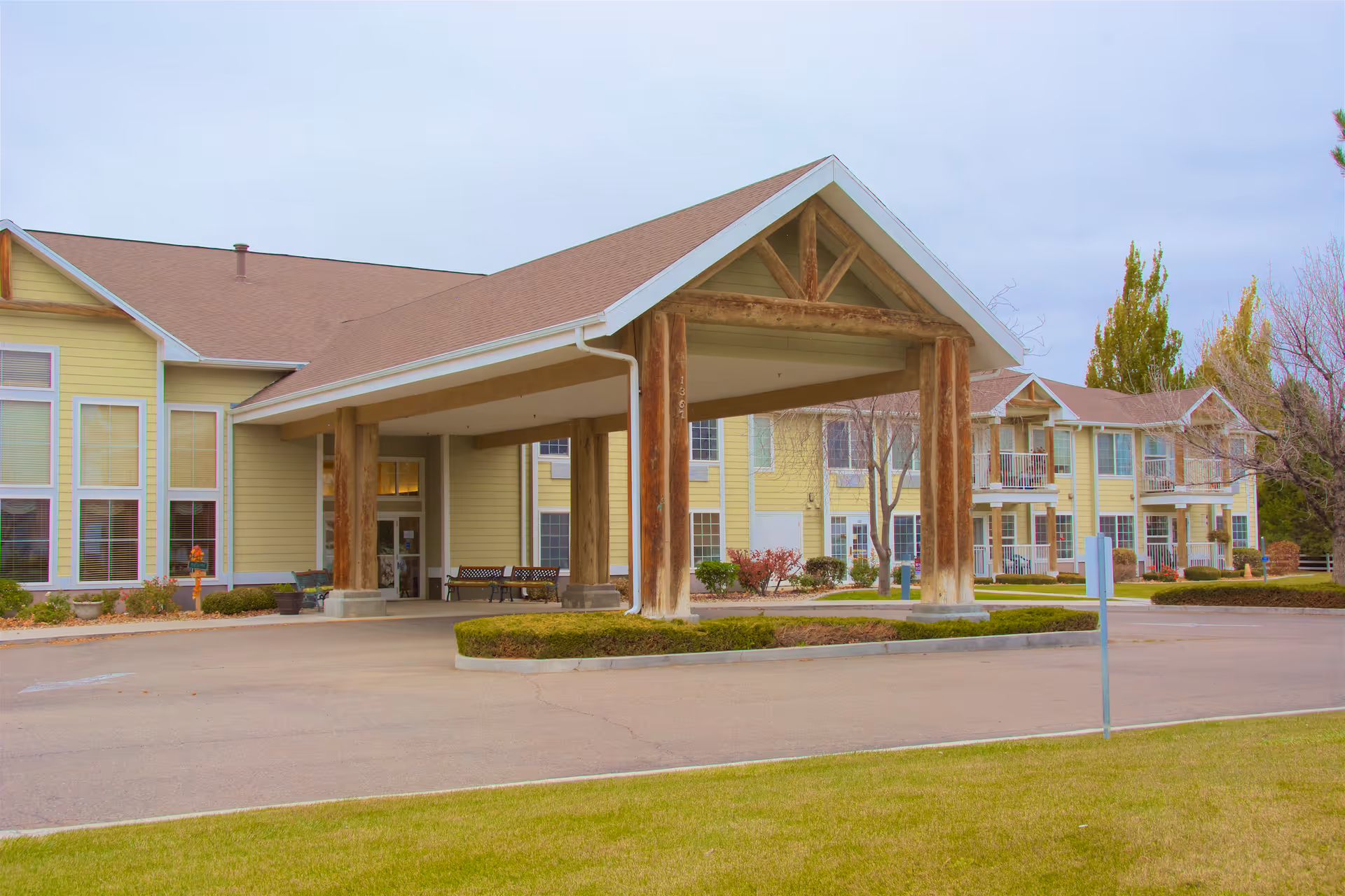 Exterior view of Brookdale Twin Falls with a covered entrance and yellow building façade.