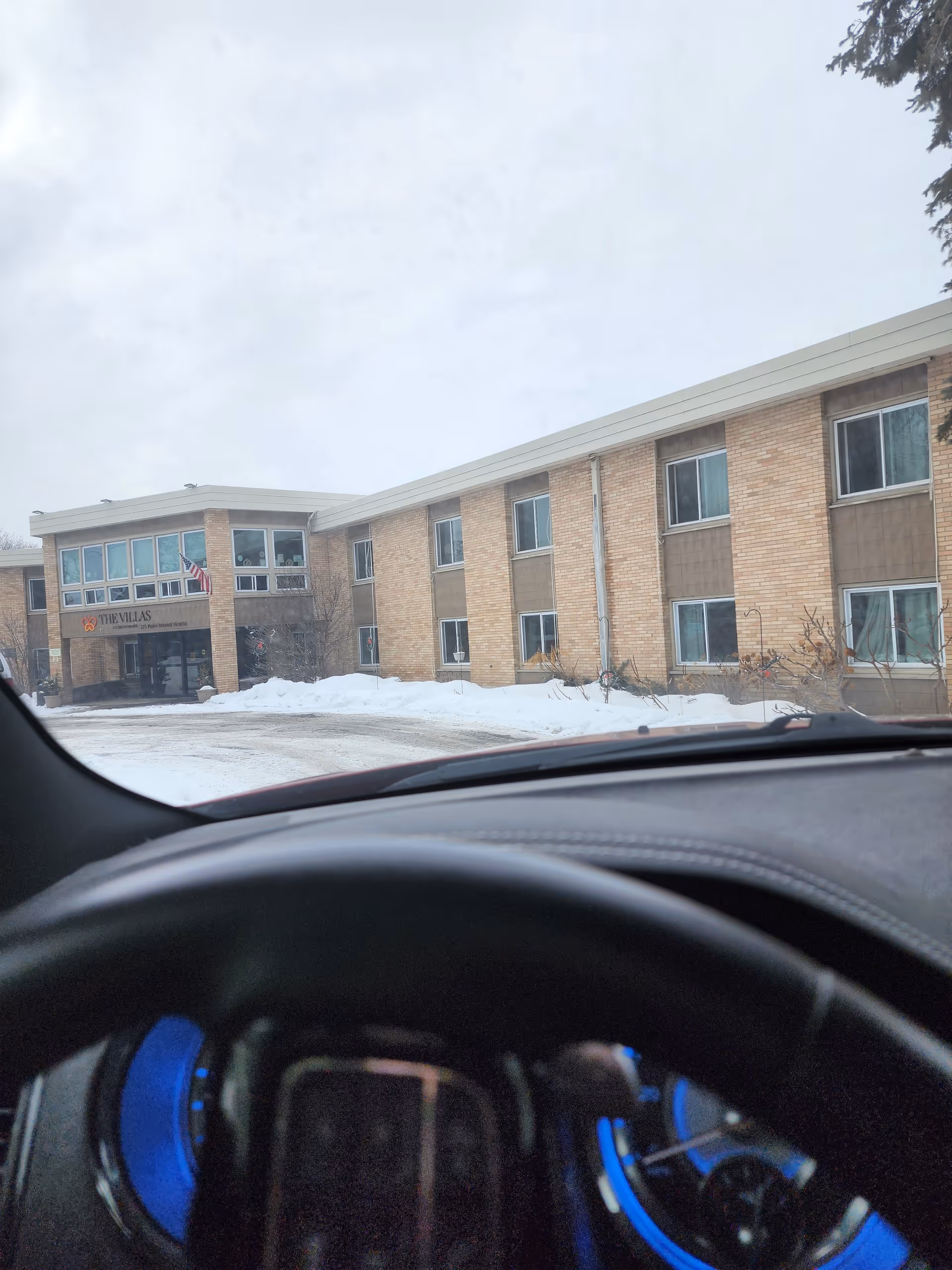 Front exterior of The Villas at Bryn Mawr building with snow in foreground.