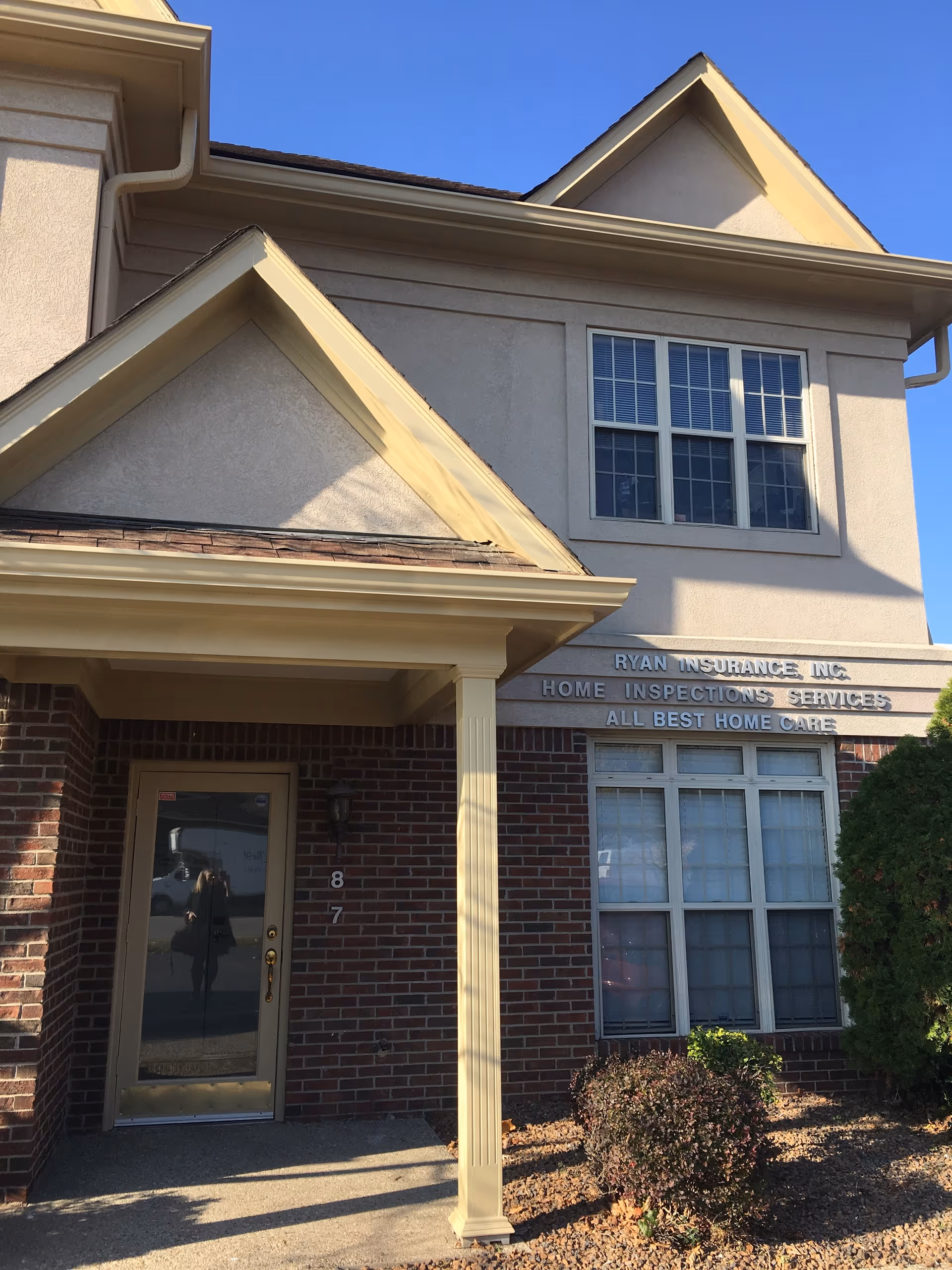 Front entrance of All Best Home Care facility with brick and beige siding.