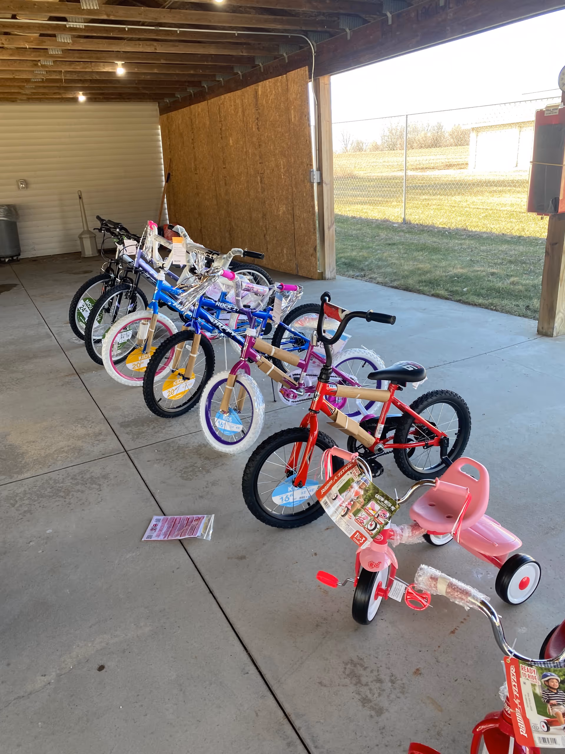 Colorful bicycles lined up under a sheltered area at the facility.