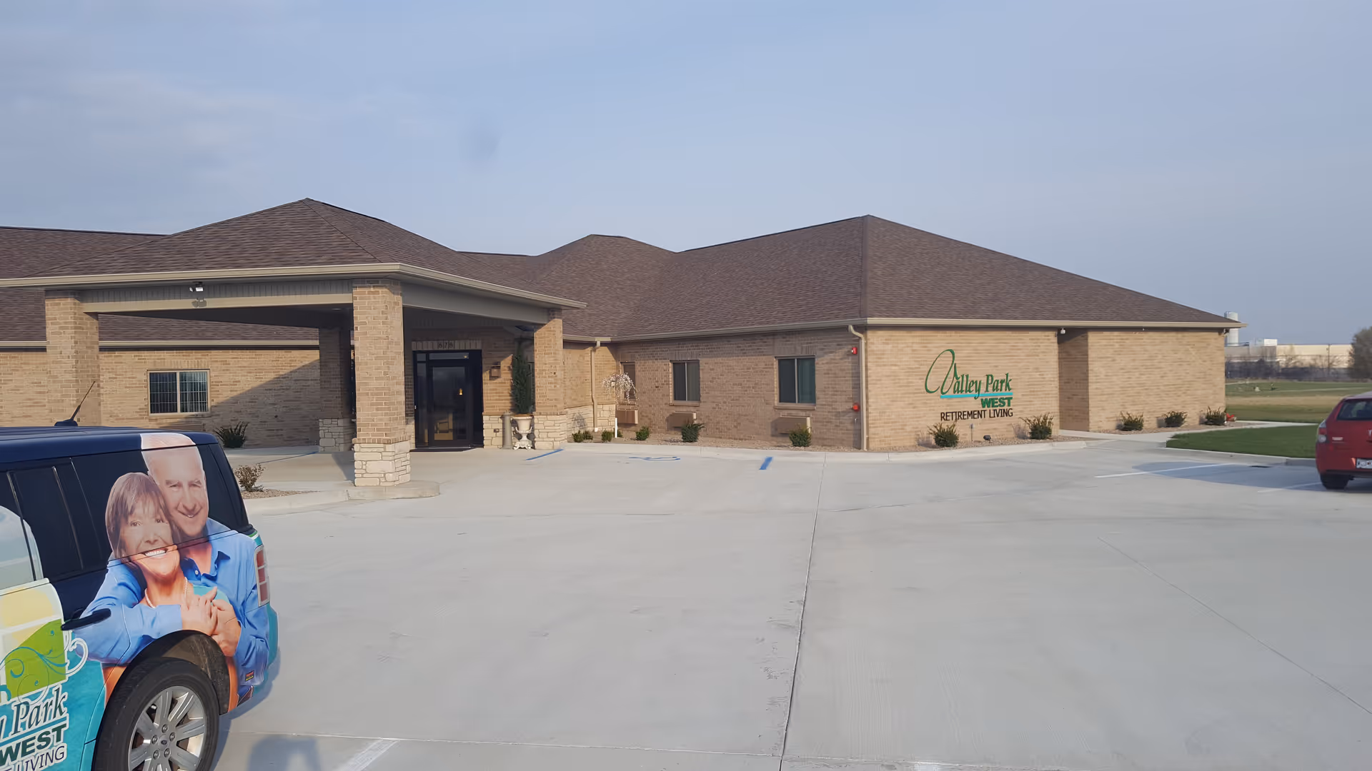 Valley Park Retirement Center exterior: brick building with entrance and parking lot.