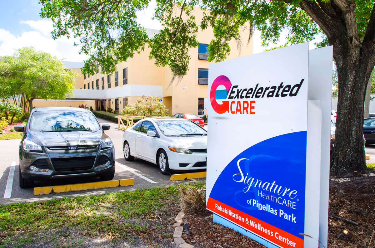 Pinellas Park Post-Acute and Rehabilitation Center exterior with large sign and parked cars.