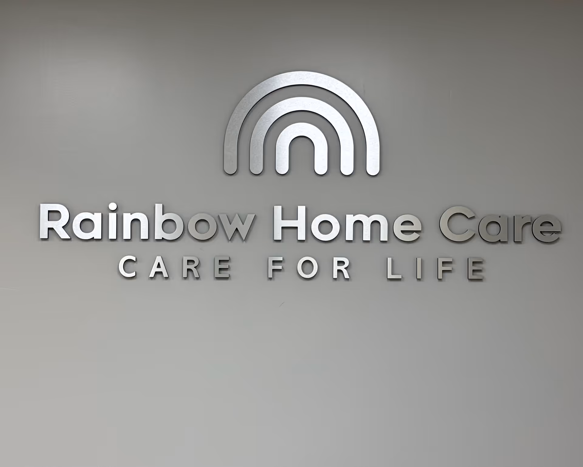 Interior wall featuring Rainbow Home Care logo and the words CARE FOR LIFE.