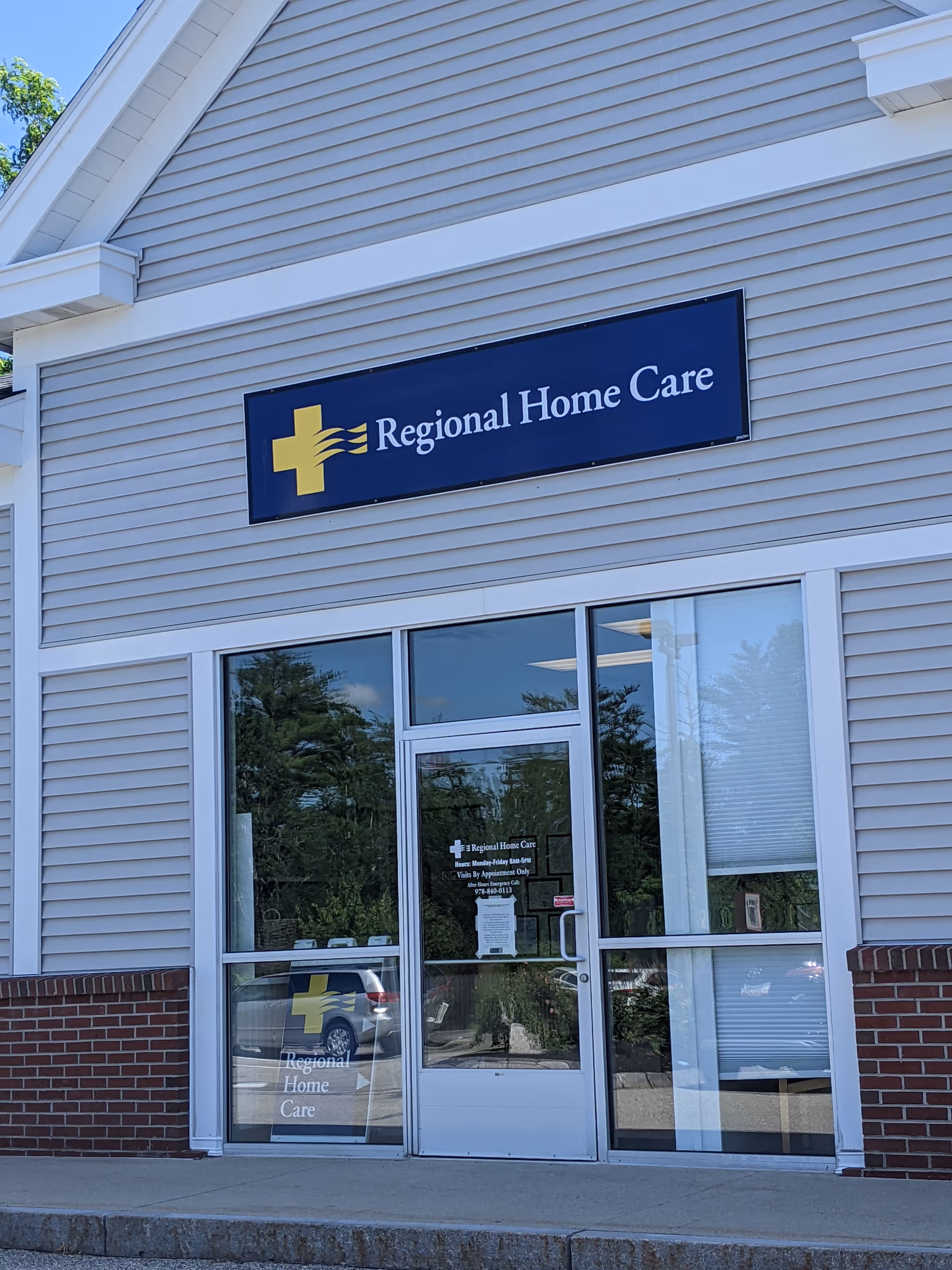 Exterior view of Regional Home Care building with glass doors and blue sign.