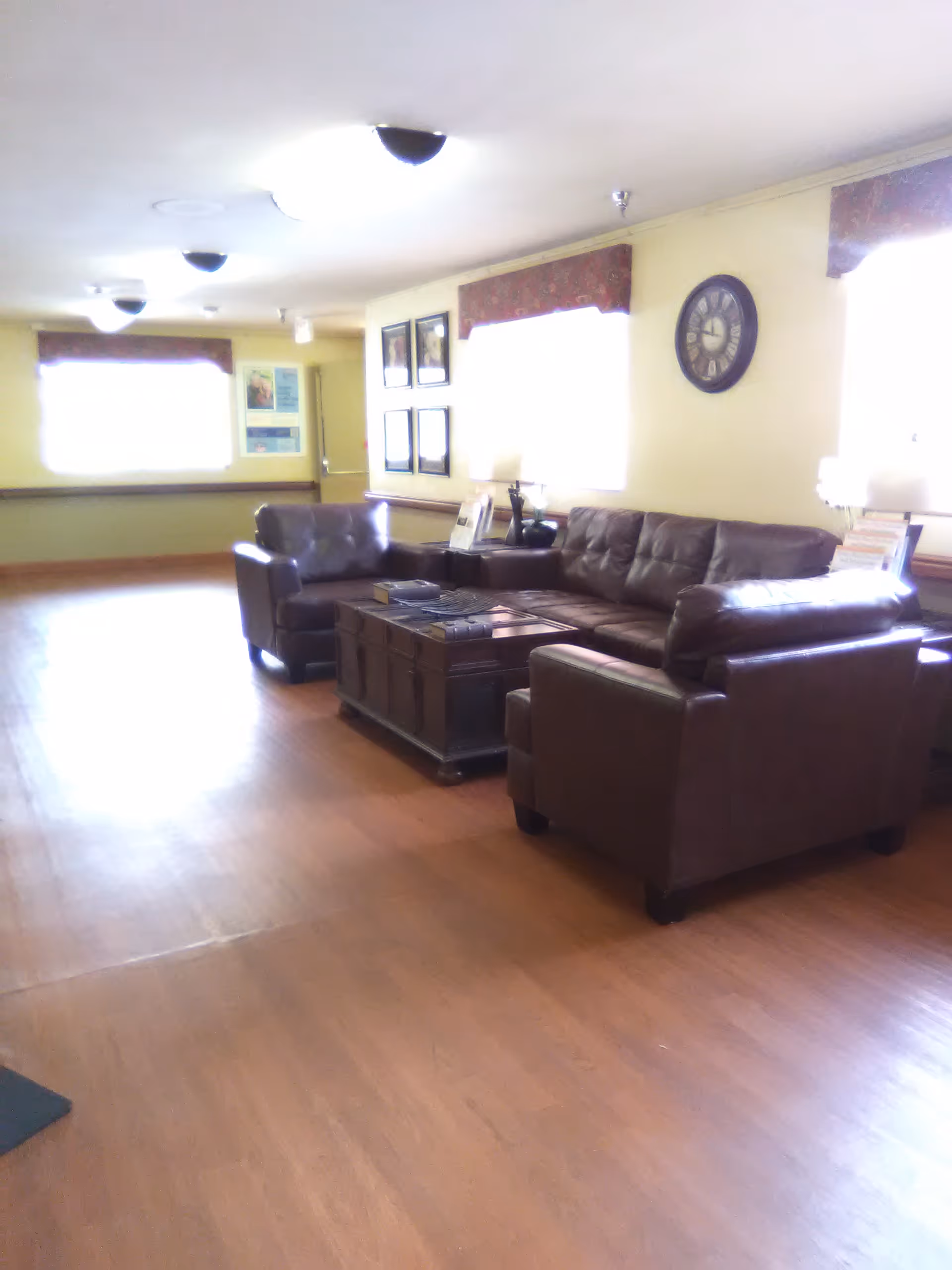 Leather lounge seating arranged around a wooden coffee table in a communal living area.