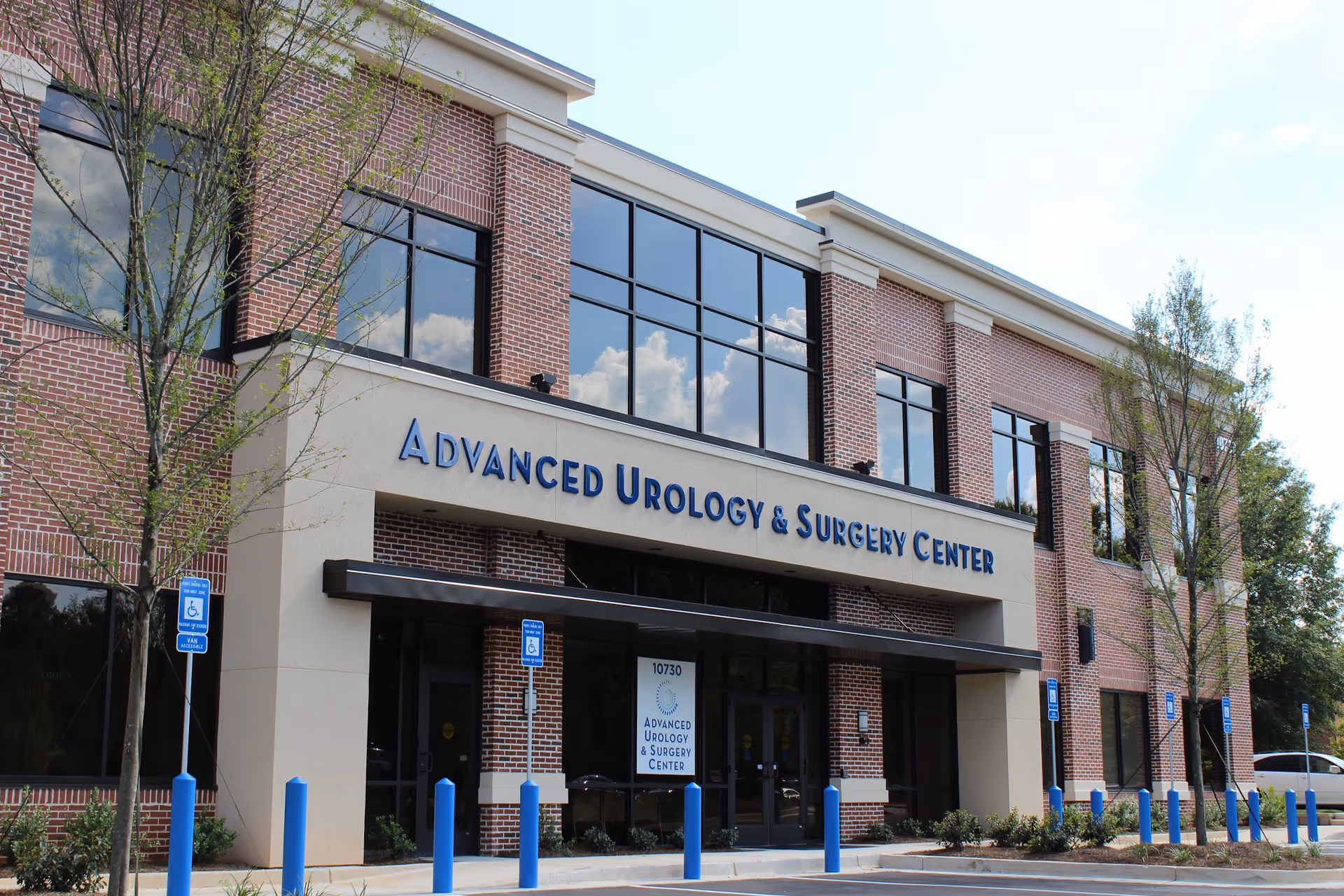 Exterior view of a brick medical center displaying Advanced Urology and Surgery Center.