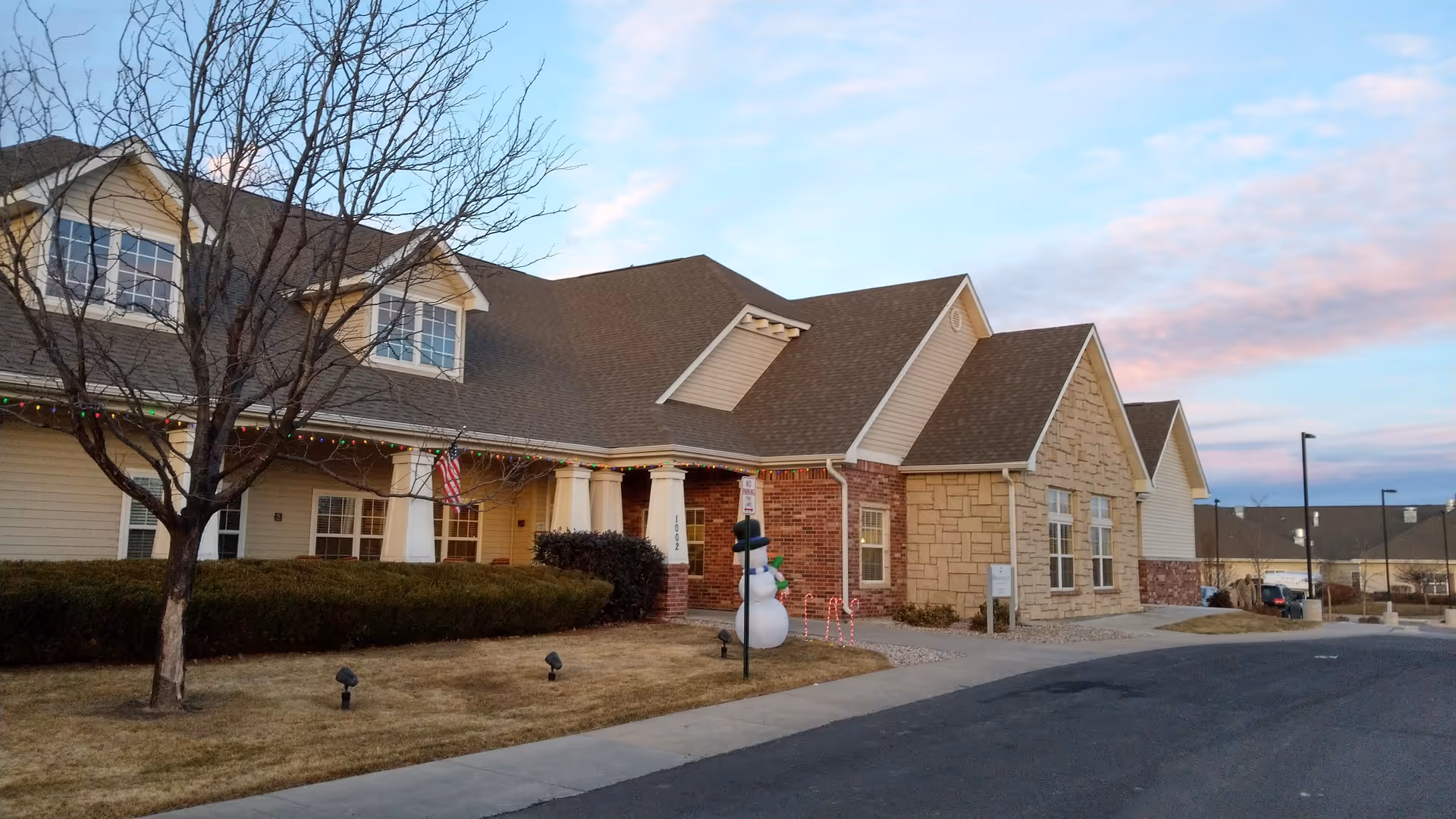 Front view of Brookdale Fort Collins Assisted Living building with holiday lights and a snowman decoration