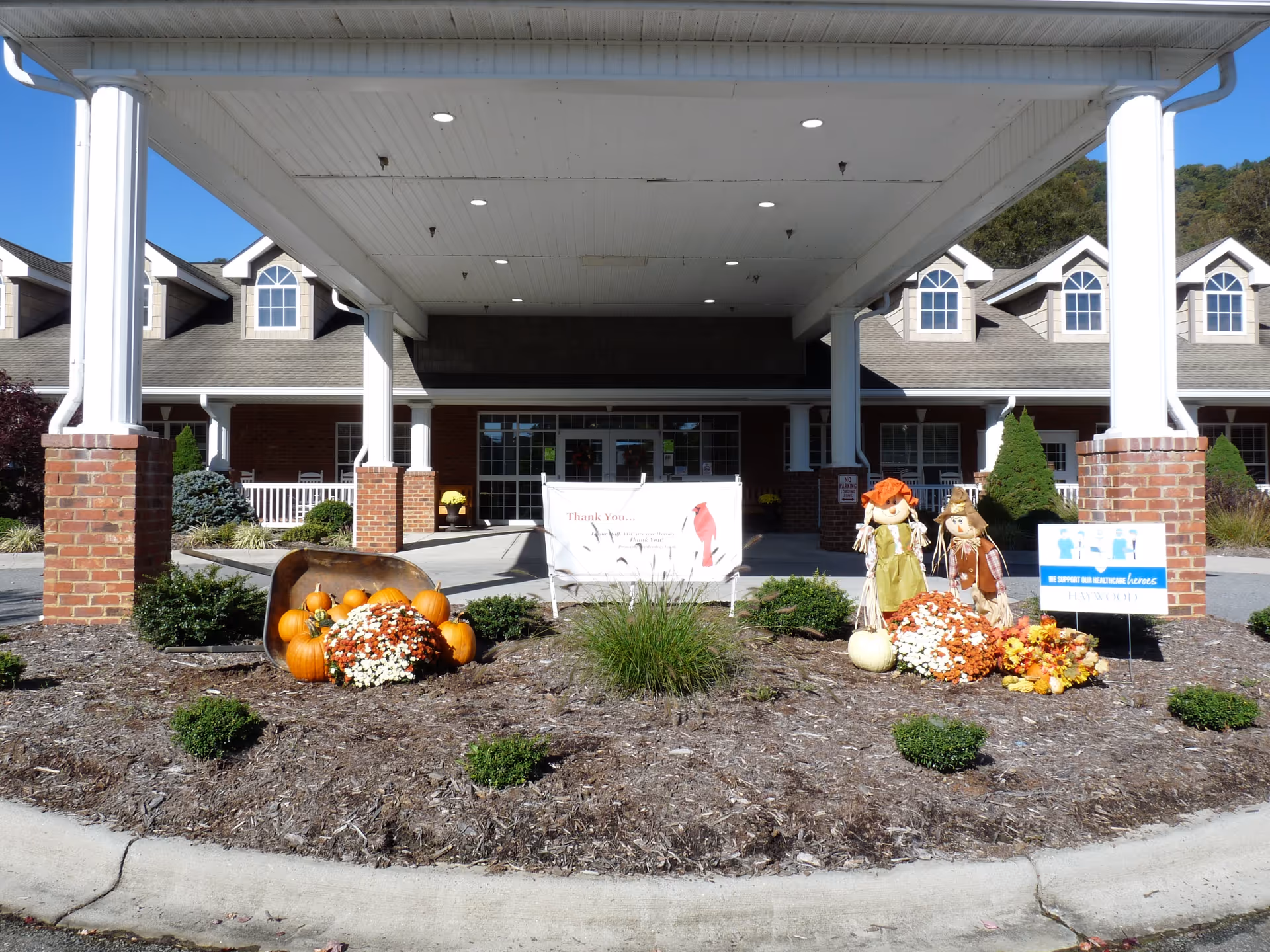 Entrance of Smoky Mountain Health and Rehabilitation Center with fall decorations and garden.