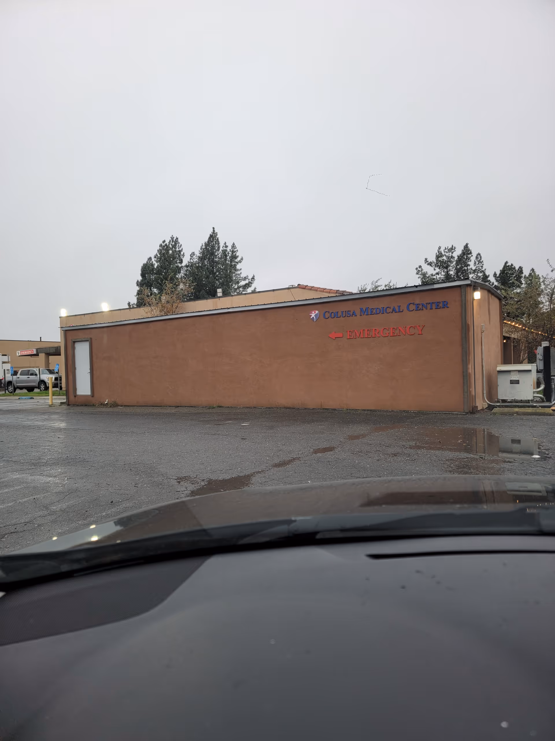 Brown single-story medical center building with Colusa Medical Center sign and Emergency arrow.