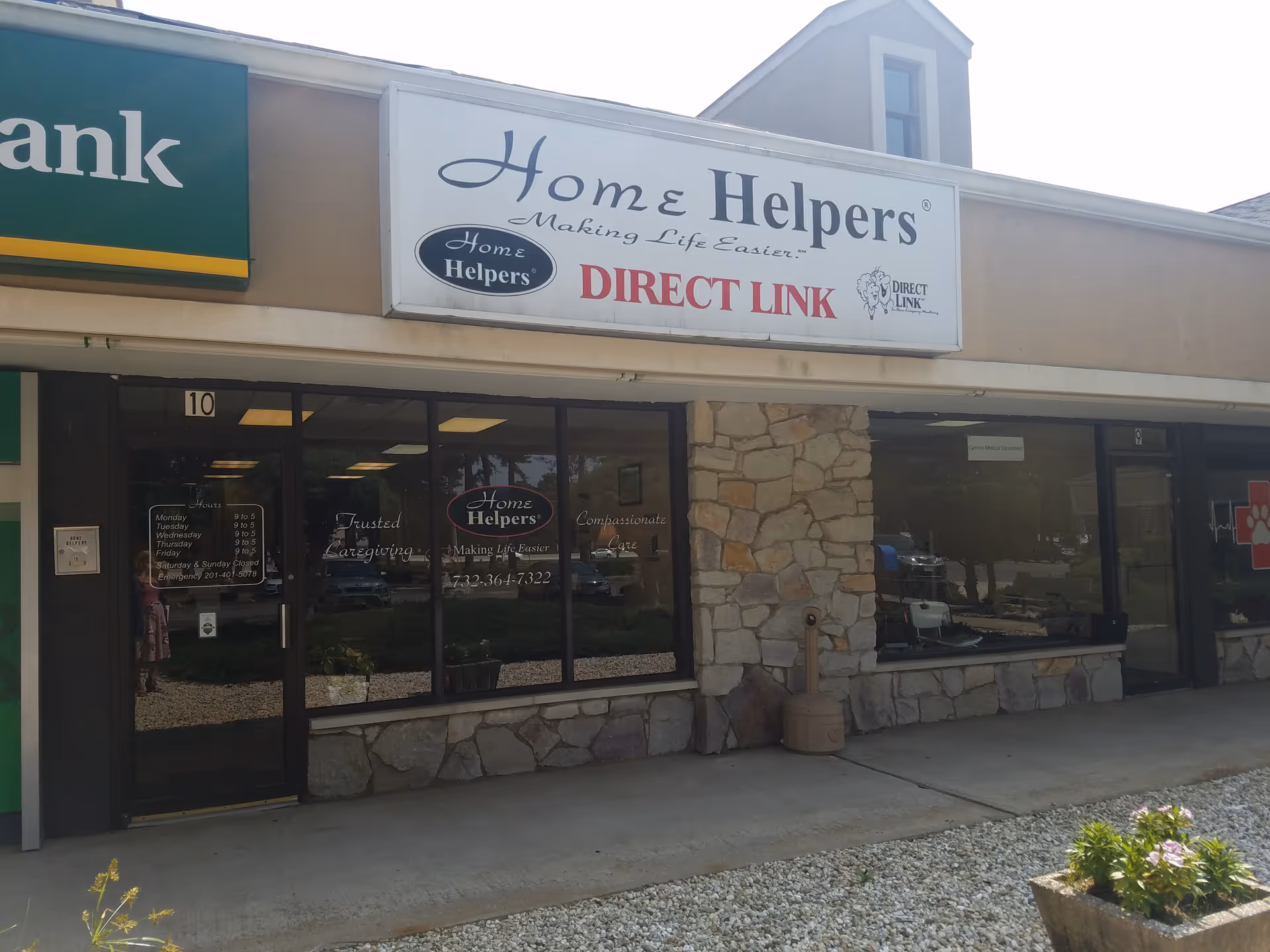 Storefront with Home Helpers Direct Link signage, stone facade, and glass windows.