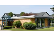 Exterior view of Elderwood at Hornell facility with brick facade and landscaped entrance.