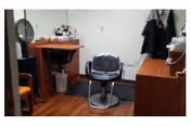 A small salon/vanity area with a central chair in a senior living facility.