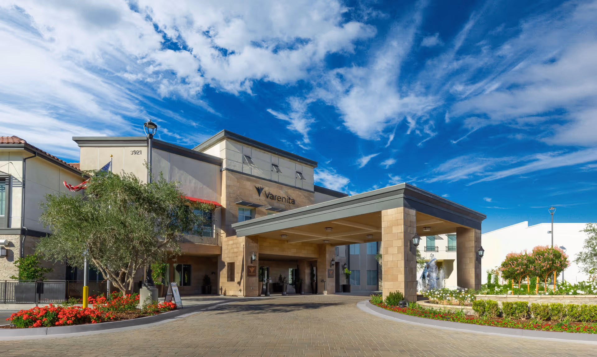 Exterior view of Varenita of Simi Valley with an entry canopy and landscaped grounds.