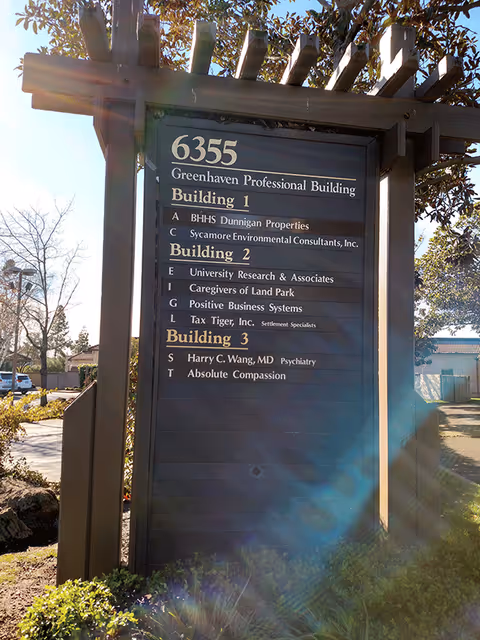 Outdoor directory sign listing Building 1, Building 2, Building 3, and Caregivers of Land Park.
