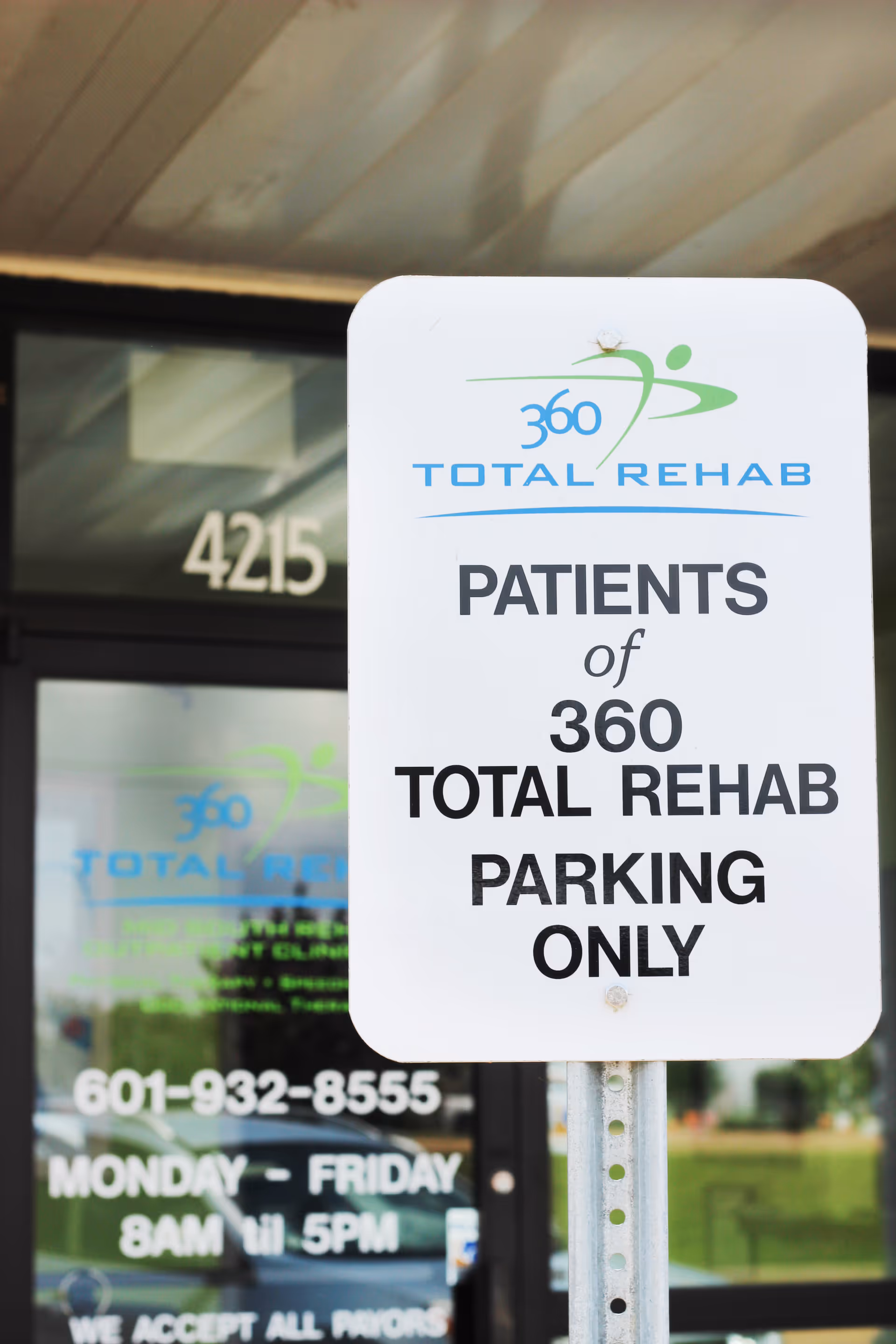 Outdoor parking sign for 360 Total Rehab in front of the facility entrance.