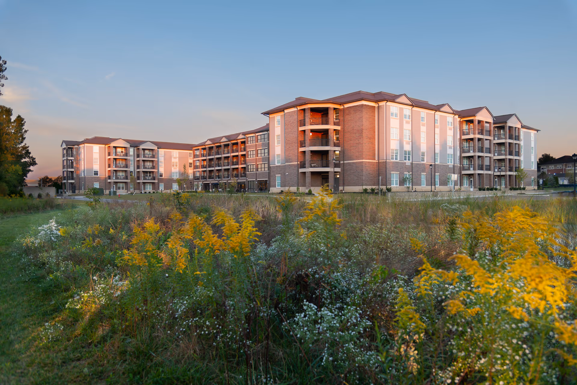 Exterior view of United Church Homes Polaris Community, a brick senior living complex with landscaped foreground.