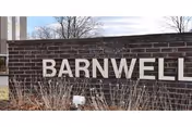 Brick wall sign reading BARNWELL at facility entrance.