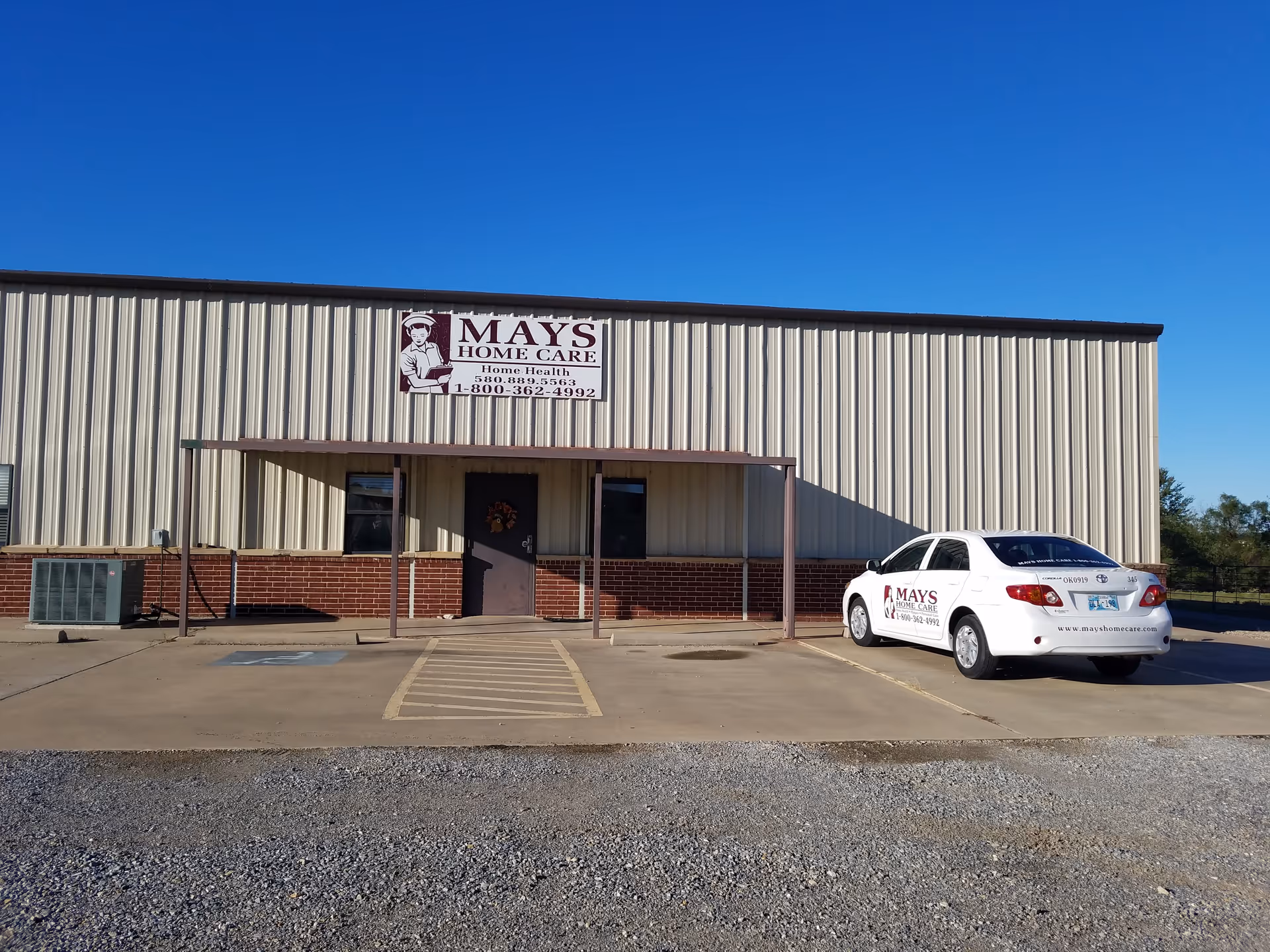Exterior view of a beige industrial-style building with a sign reading MAYS HOME CARE.