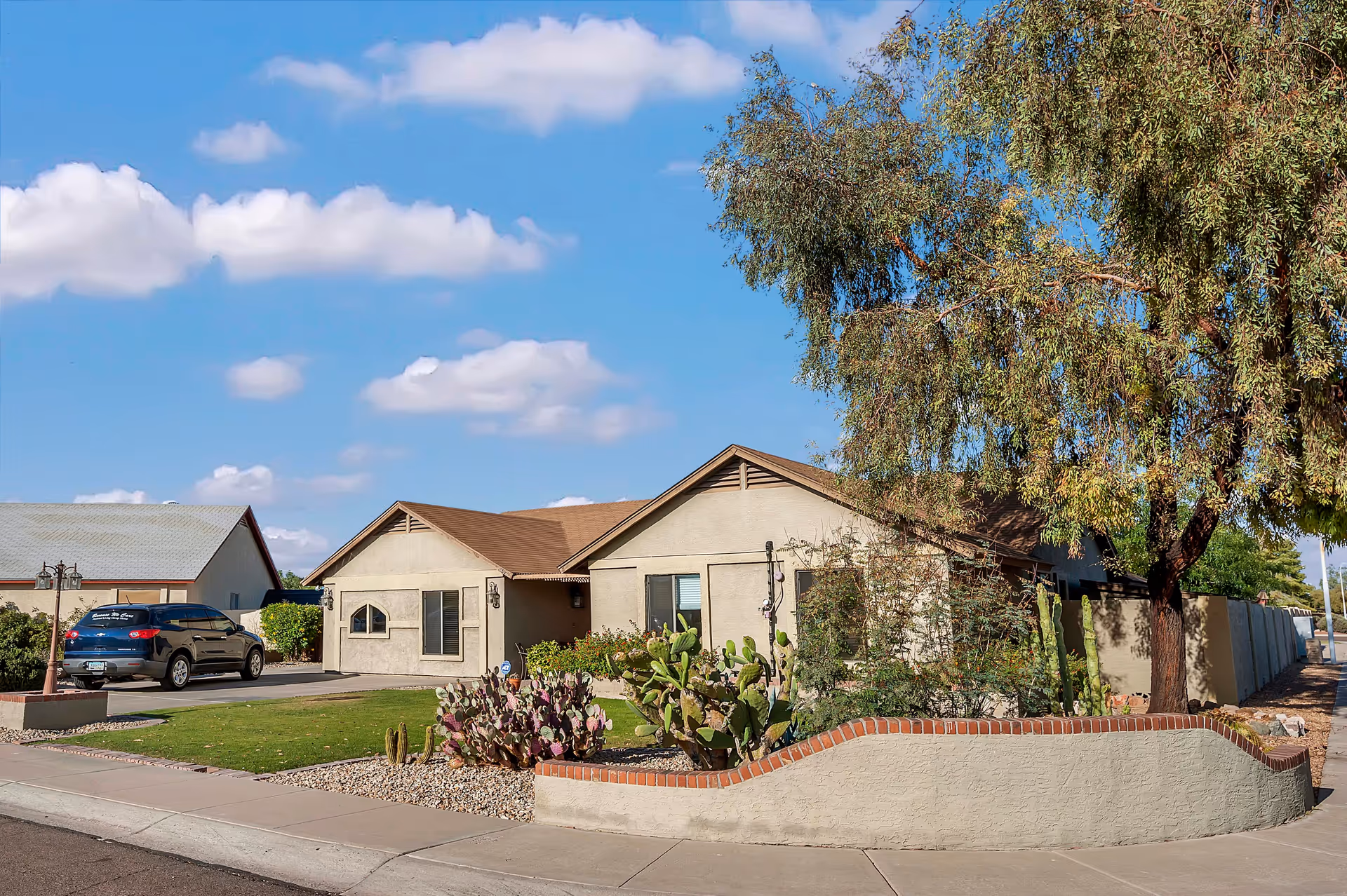 Single-story facility with desert landscaping and a curved brick planter.